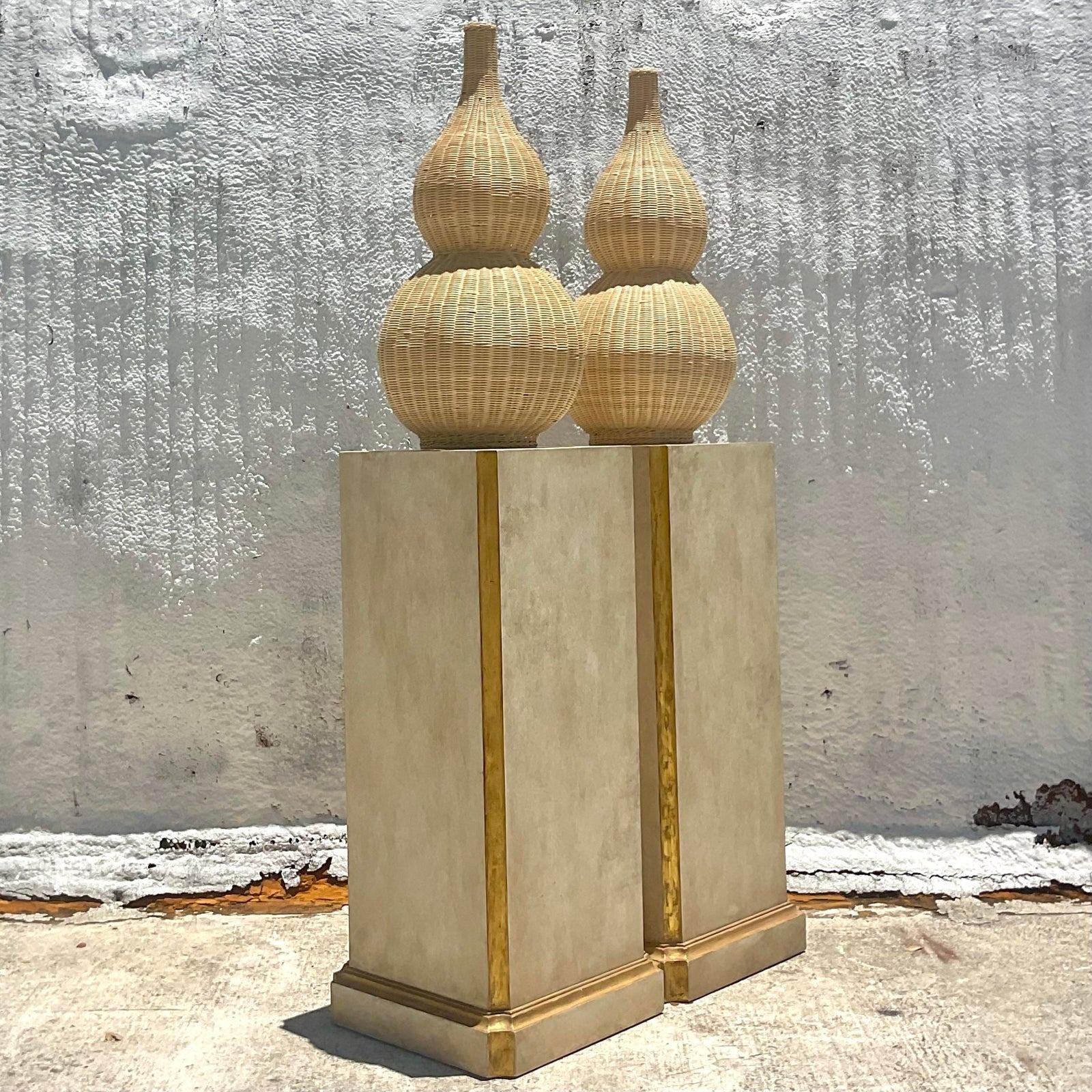 An extraordinary pair of vintage Regency pedestals. Tall and chic with a patinated white finish and gilt tipping. Perfect for your statuary, urns or flowers. You decide! Absolutely incredible. Acquired from a Palm Beach estate.