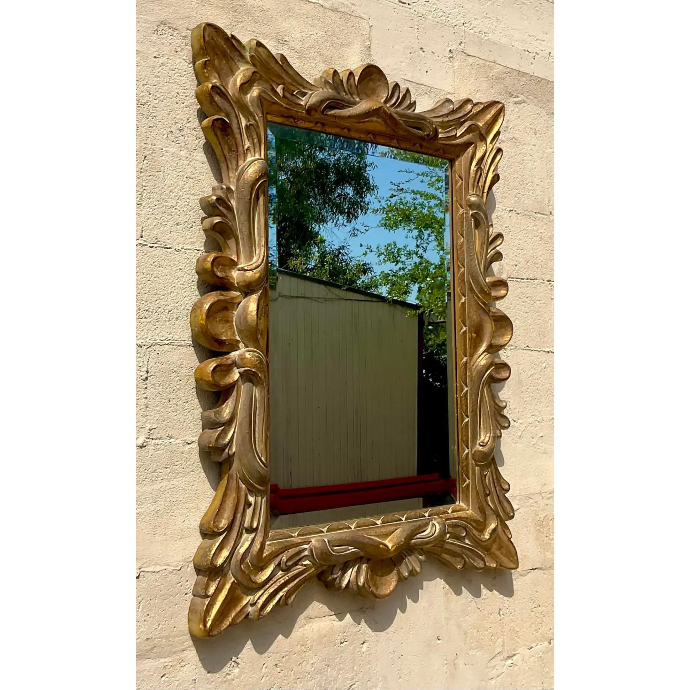 A fantastic vintage Regency gilt mirror. A chic molded composite covered in bright gold. A beautiful design full of flourish. Two mirrors available on my Chairish page if a pair is needed. Acquired from a Palm Beach estate