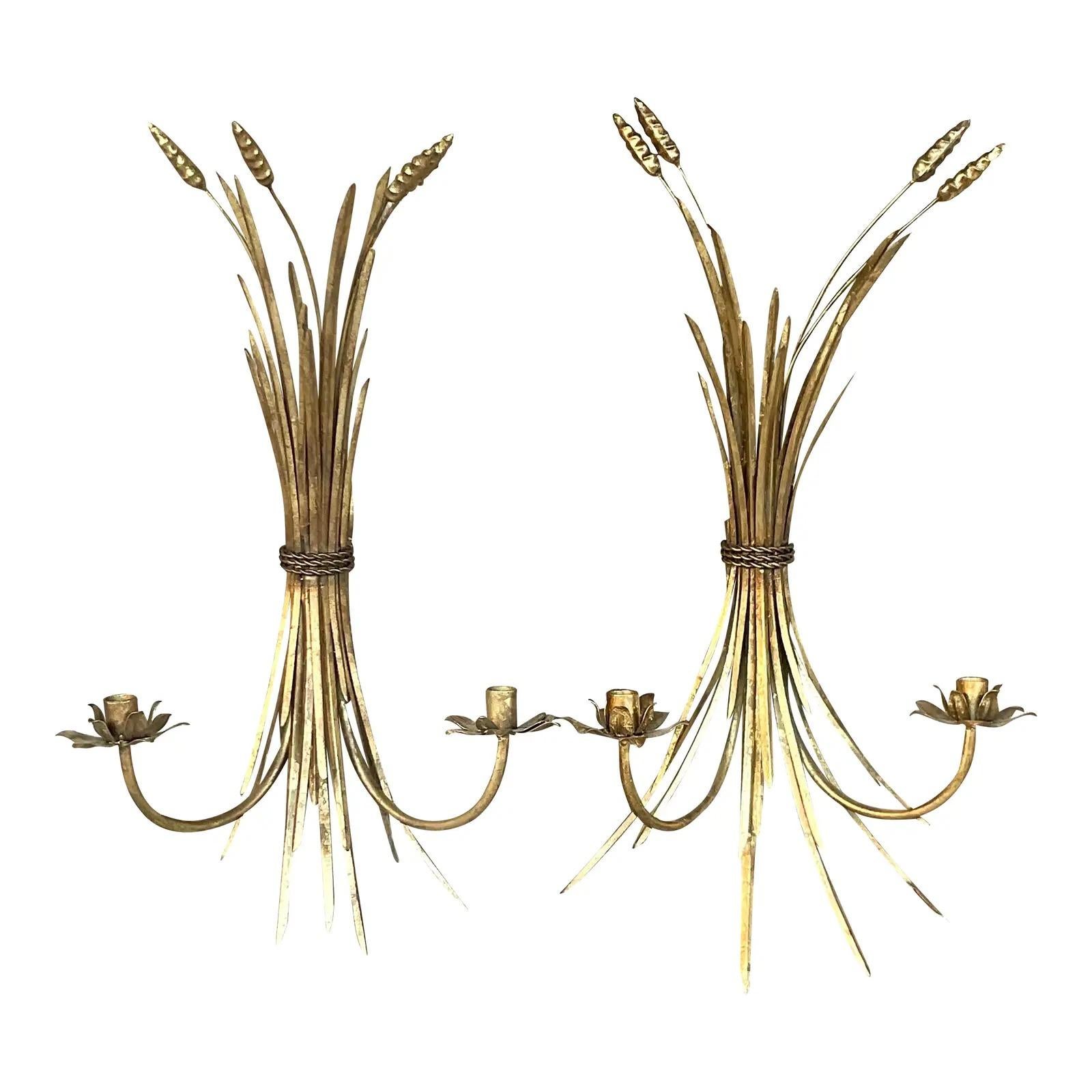 A fabulous pair of vintage Gilt candle sconces. An iconic wheat sheath design with two candle holders each. Acquired from a Palm Beach estate. 