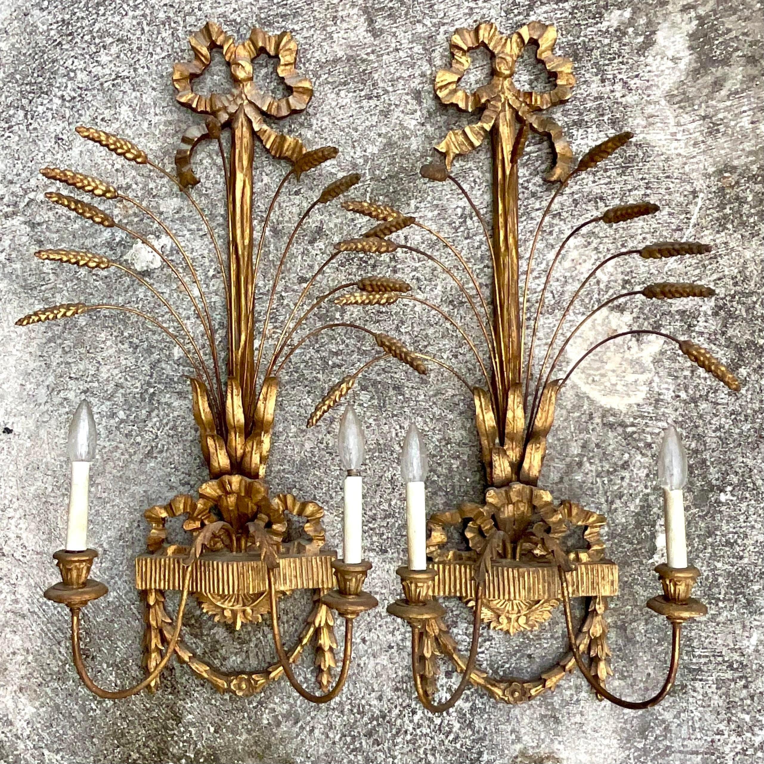 A stunning pair of vintage Regency wall sconces. Beautiful gilt finish on a bundled wheat design. Acquired from a Palm Beach estate.
