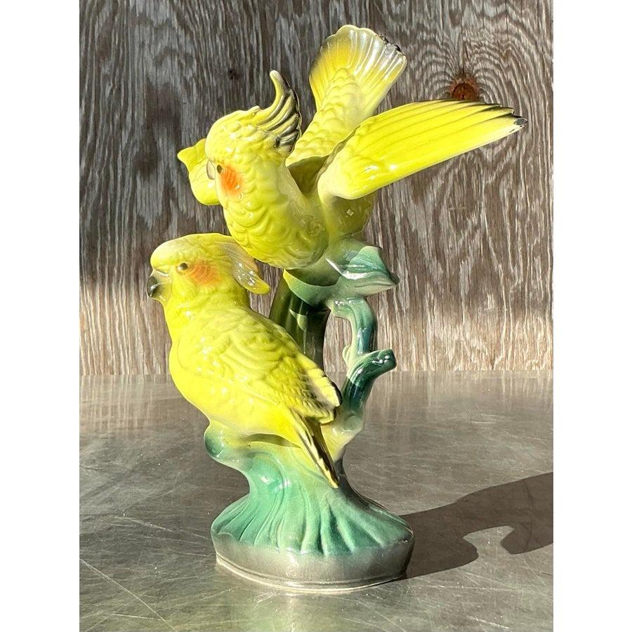 Bring an air of tropical elegance to your space with this exquisite vintage ceramic sculpture of two vibrant cockatoos. Featuring a beautifully detailed design, the cockatoos showcase radiant yellow and green hues with a high-gloss glaze that