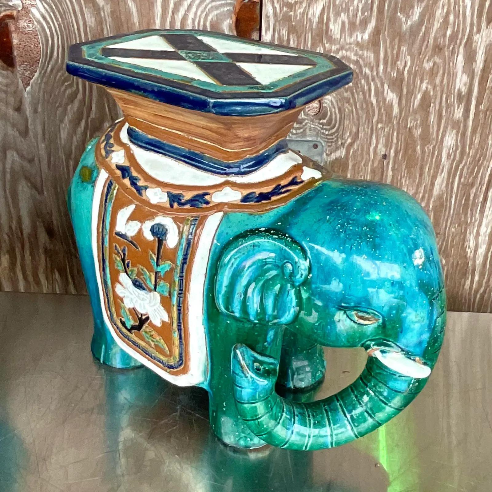 A fabulous Vintage Regency glazed ceramic elephant. A brilliant blue green color with a classic design. Trunk up for good luck! Acquired from a Palm Beach estate.