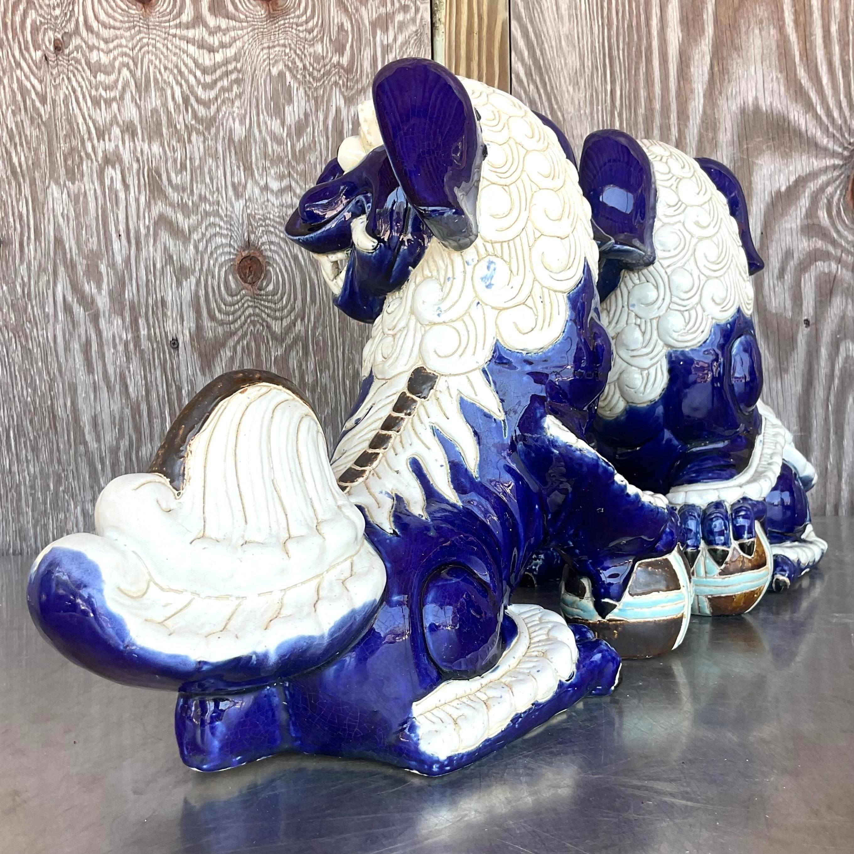 Elevate your decor with a touch of classical elegance with our Vintage Regency Glazed Ceramic Foo Dogs. Inspired by traditional Asian motifs and reimagined with American flair, this pair exudes timeless sophistication, adding a regal presence to any