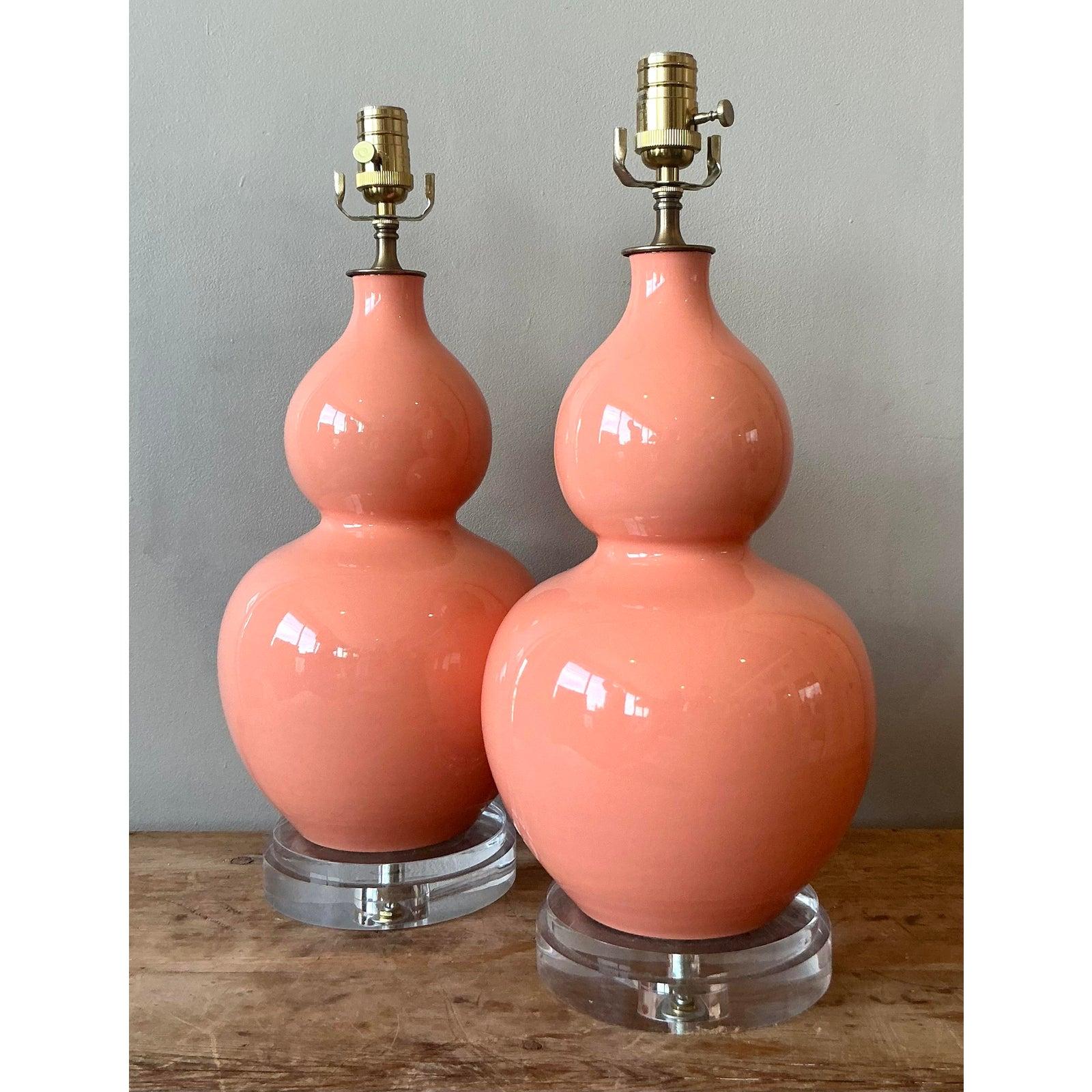 Presenting an exquisite pair of vintage Hollywood Regency gourd lamps, radiating timeless elegance and sophisticated charm. These lamps feature beautifully sculpted ceramic bodies with a lustrous, high-gloss glaze in a captivating coral hue,
