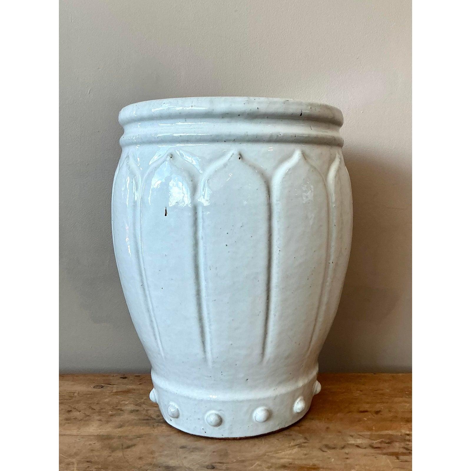 Discover the versatile elegance of this vintage glazed ceramic garden stool, a charming piece that embodies the sophisticated allure of the Hollywood Regency era. Crafted with a beautiful, subtly ribbed design and finished in a lustrous, creamy