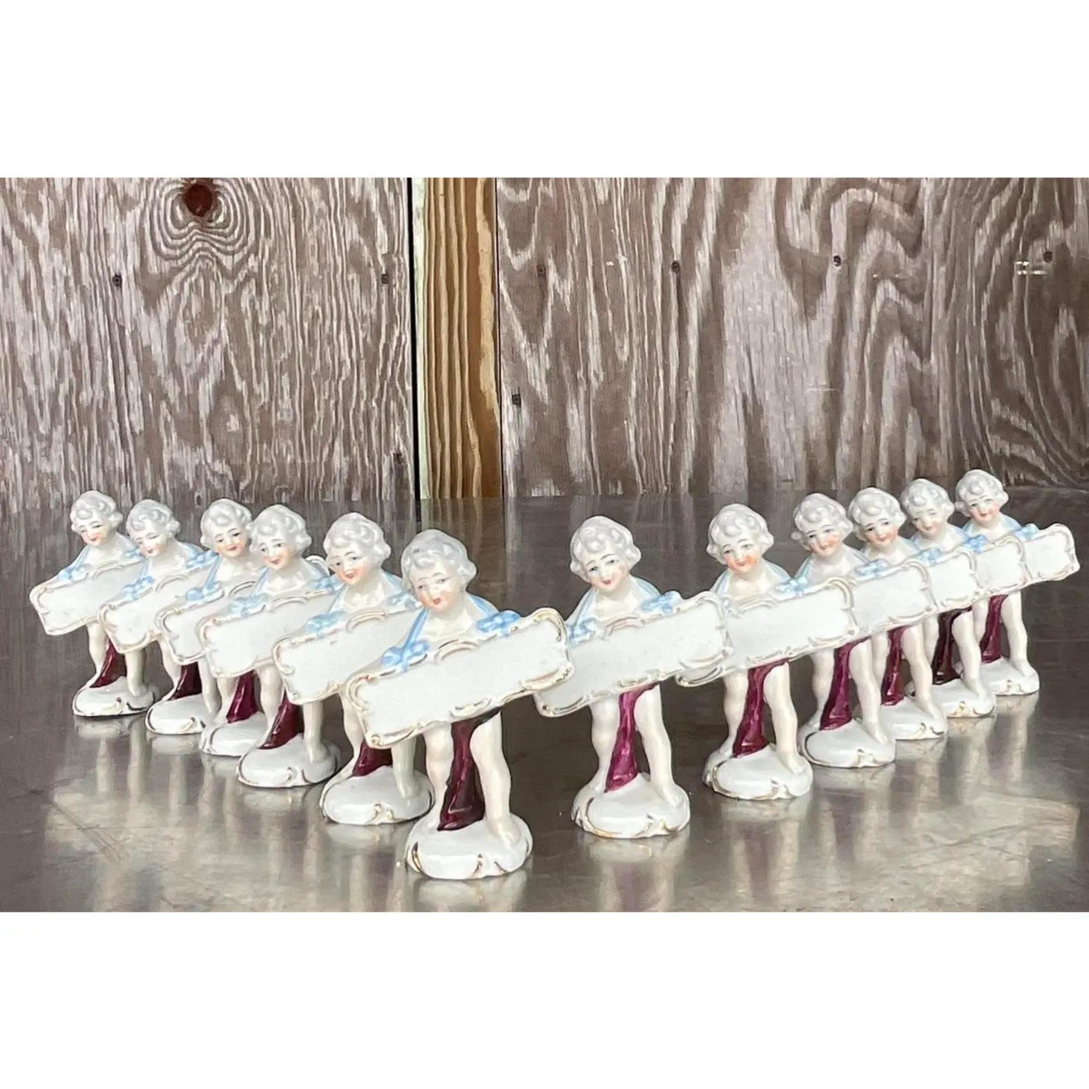 An amazing set of vintage Regency place holders. 13 Chic showgirls each holding a placard where you can write the name of your guest. Hand painted with a glazed ceramic finish. Super charming. Acquired from a Palm Beach estate. 