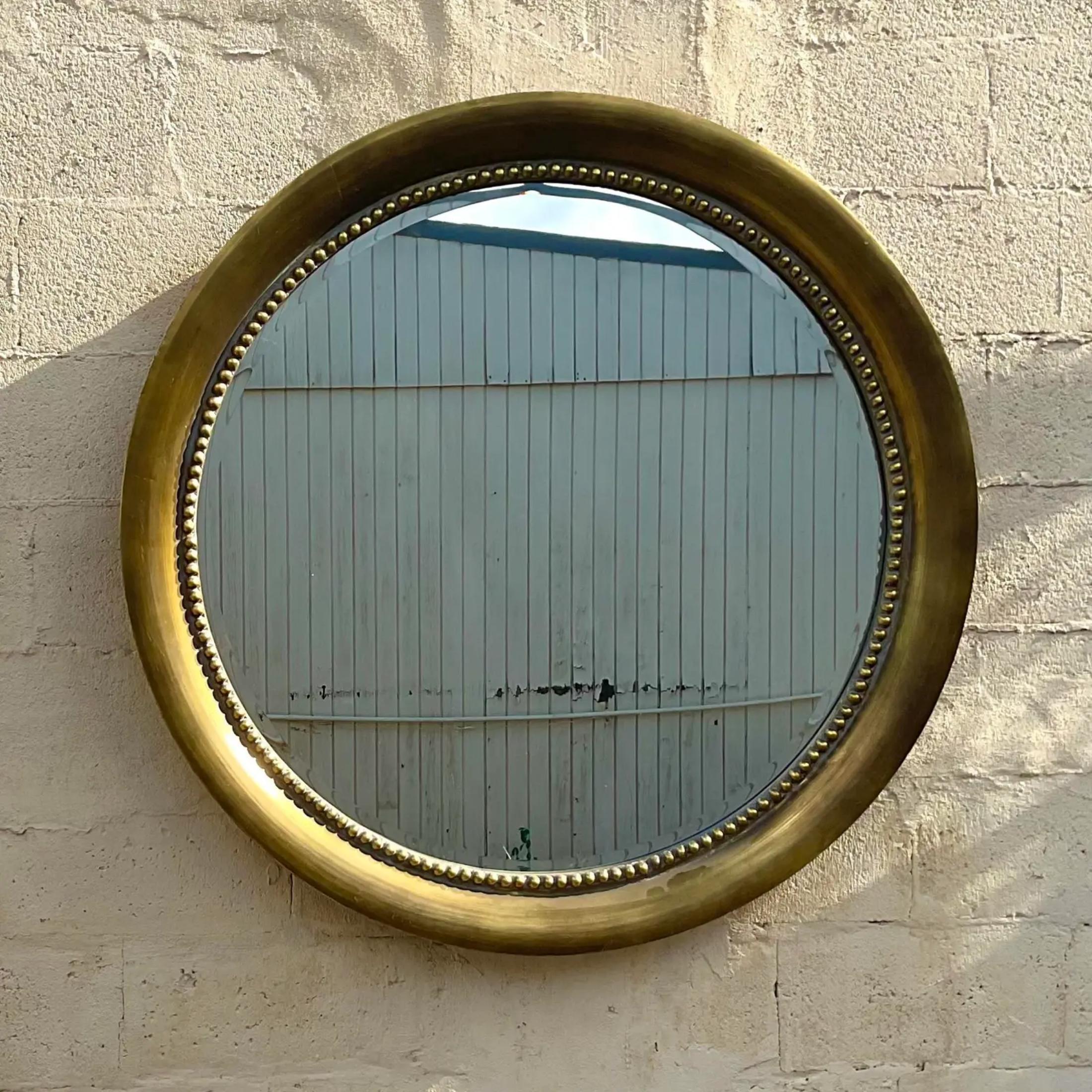 An absolutely gorgeous golden circle mirror that adds a touch of glamour to any room. Acquired at a Palm Beach estate.