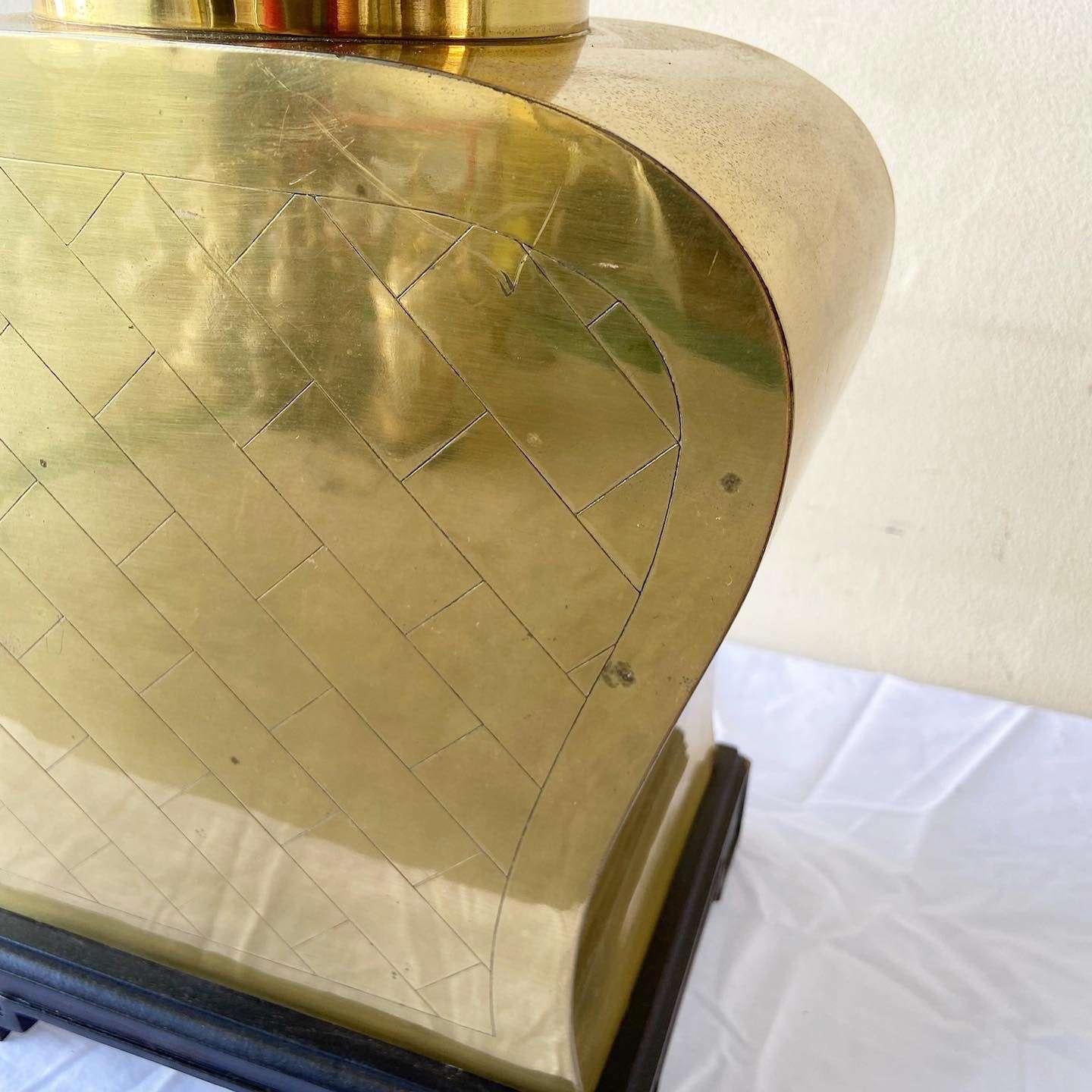 Exceptional vintage golden table lamp. Features a sculpted body on a wooden base.
