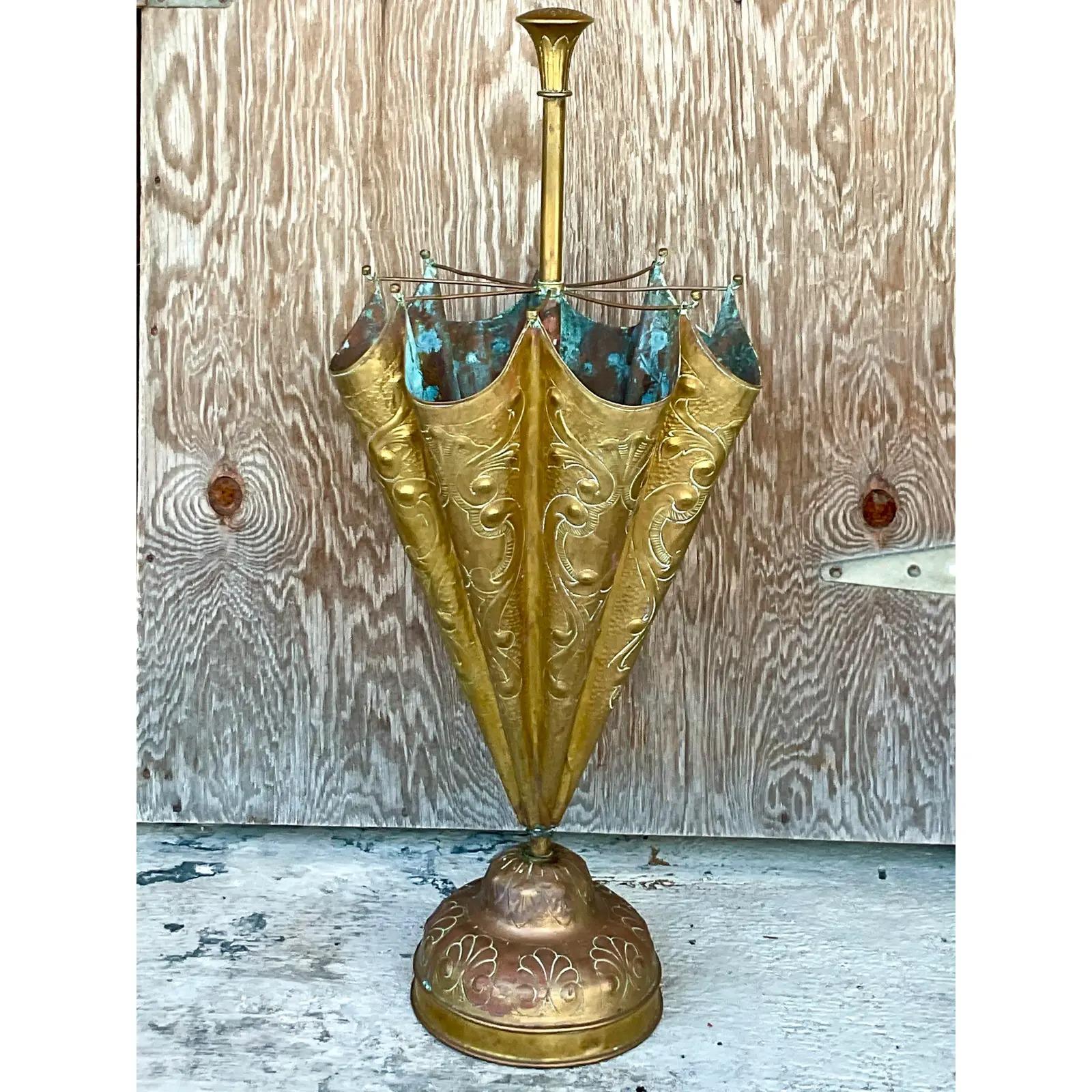 Stunning vintage Regency umbrella stand. Beautiful hammered brass in a chic and charming design. Beautiful patina to the brass from time. Acquired from a Palm Beach estate.