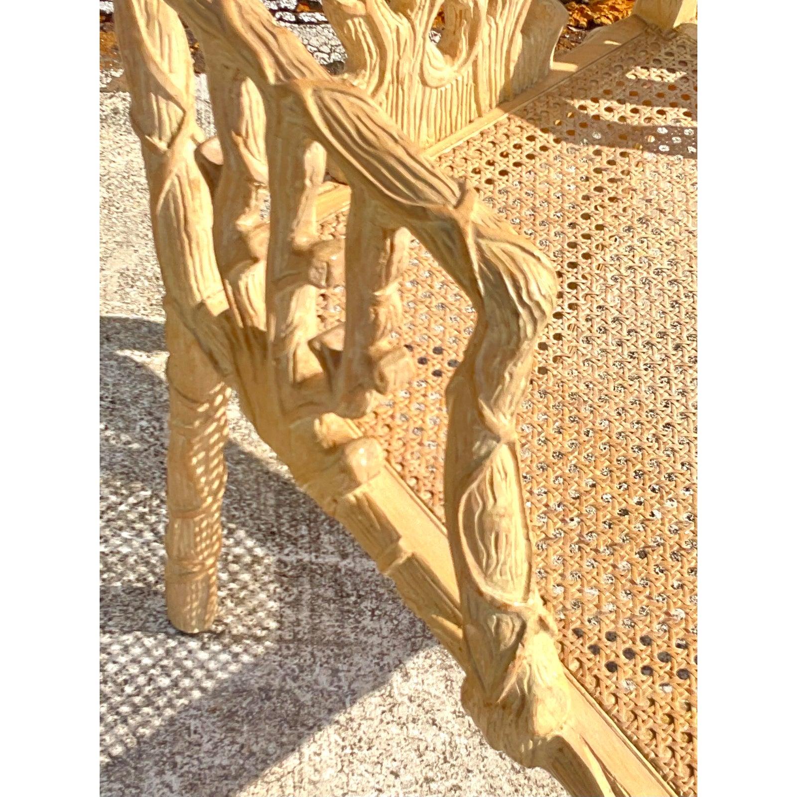 Stunning vintage Faux Bois arm chair. Gorgeous hand carved detail with a chic branches design. Cane seat adds to the glamour. Perfect as a side chair or even pulled up to a glamorous writing desk. Acquired from a Palm Beach estate.