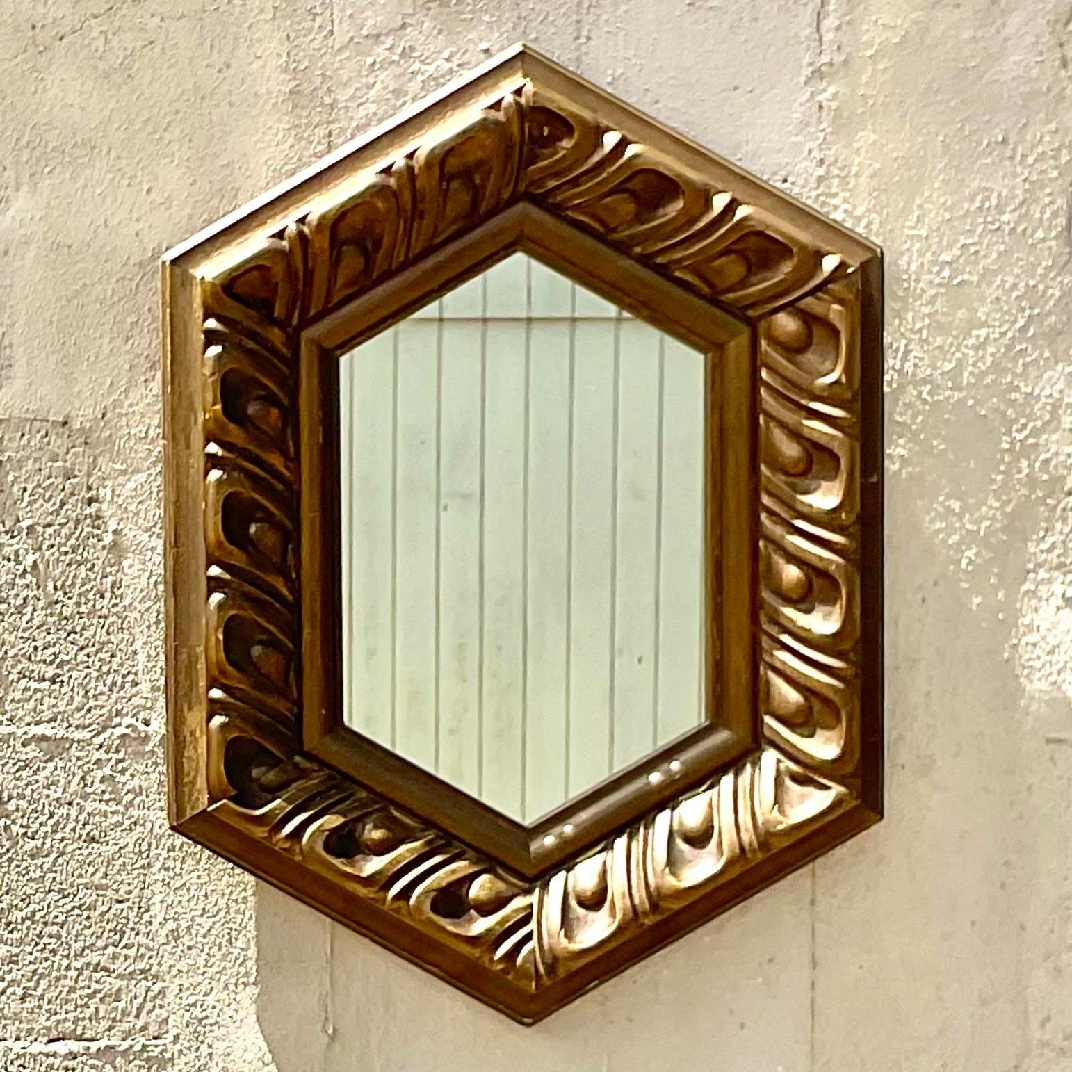Fabulous vintage Regency mirror. Beautiful carved detail with a chic hexagon shape. Acquired from a Palm Beach estate.