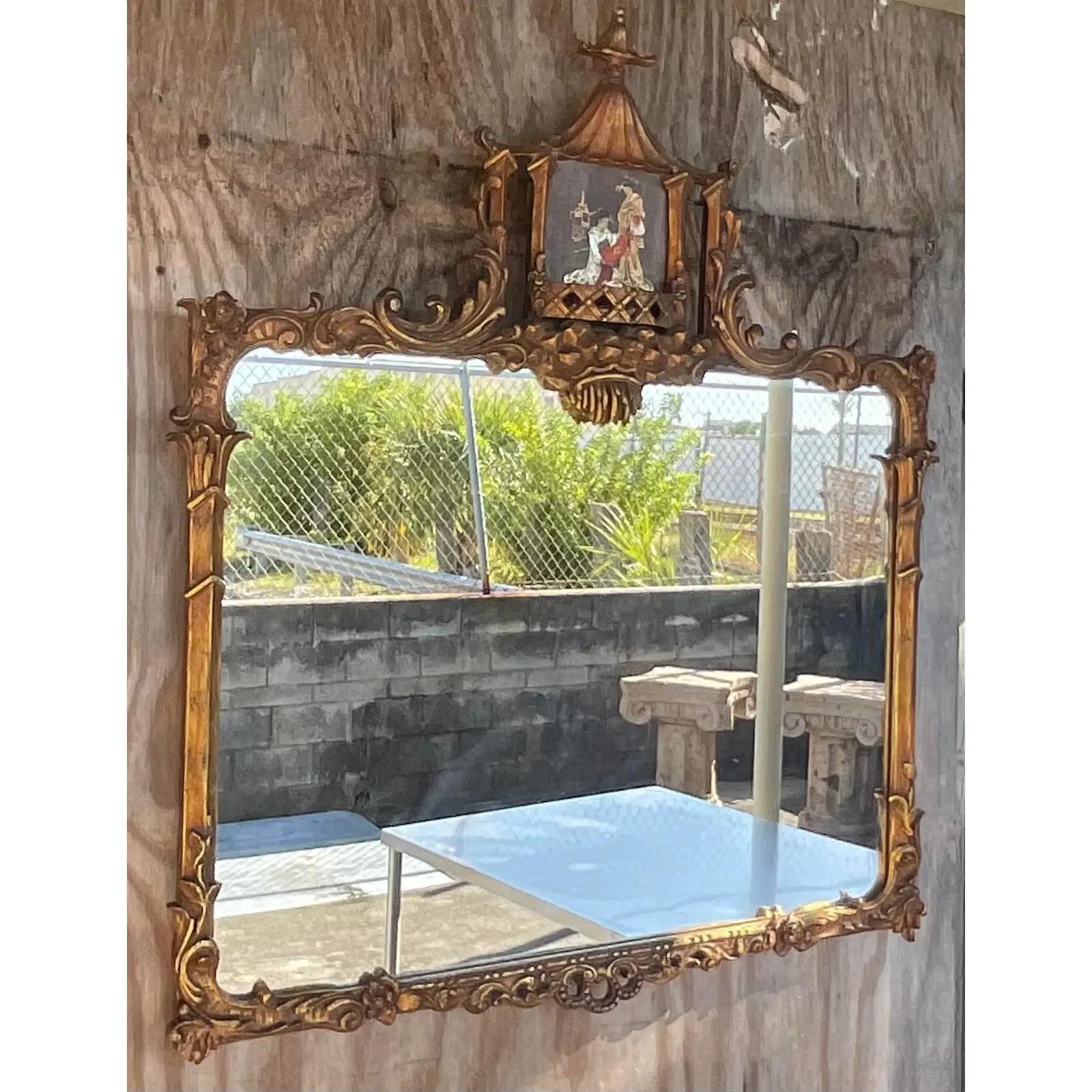 Incroyable miroir vintage sculpté à la main. Le style très convoité de la Pagode avec une belle scène de Chinoiserie peinte à la main sur le dessus. Acquis d'une propriété de Palm Beach.