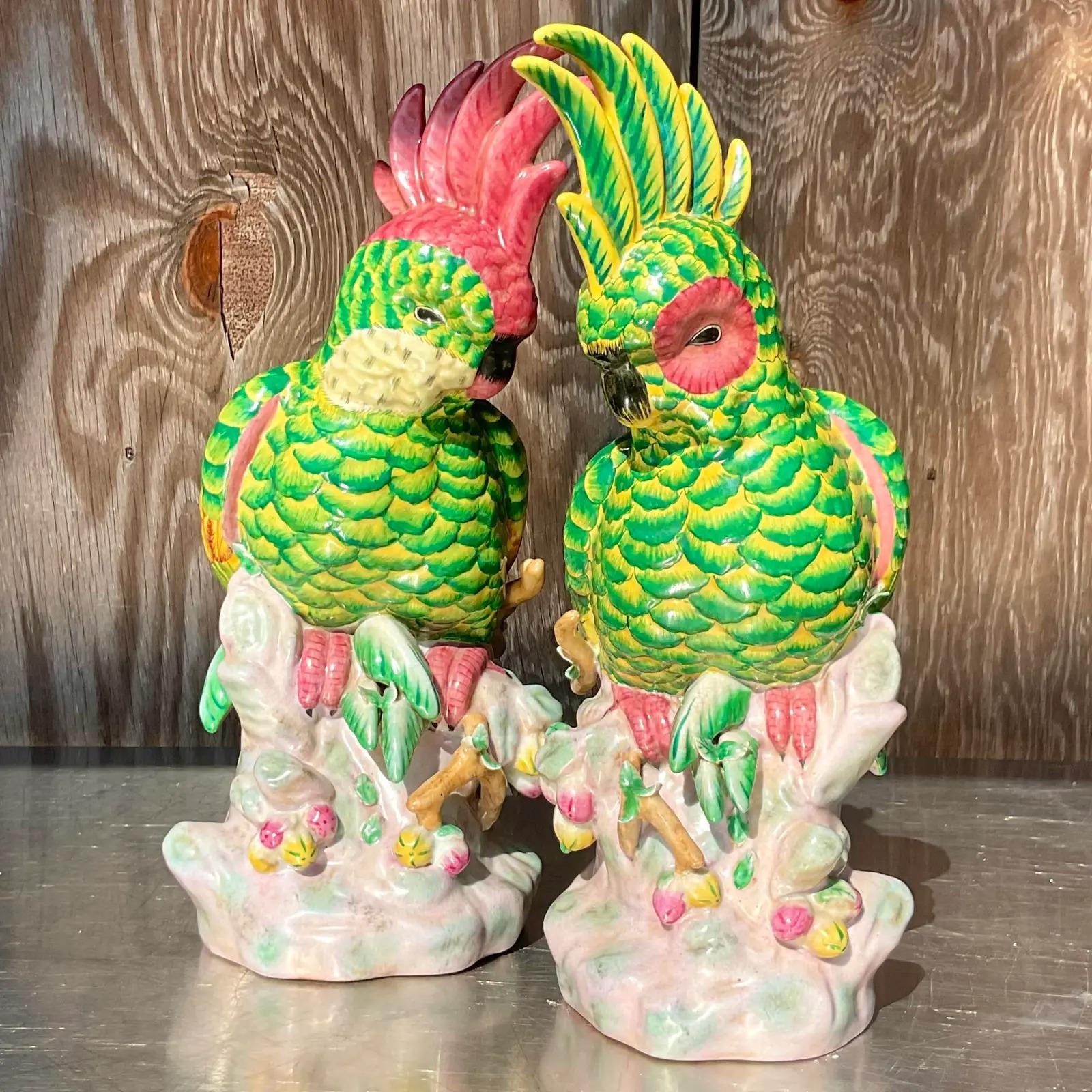 Vintage pair of Regency glazed ceramic cockatoos. Beautiful hand painted detail in bright clear colors. Perfect as is or would also be fabulous converged to lamps. You decide! Acquired from a Palm Beach estate.

Smaller bird dimensions - 7 x 7 x