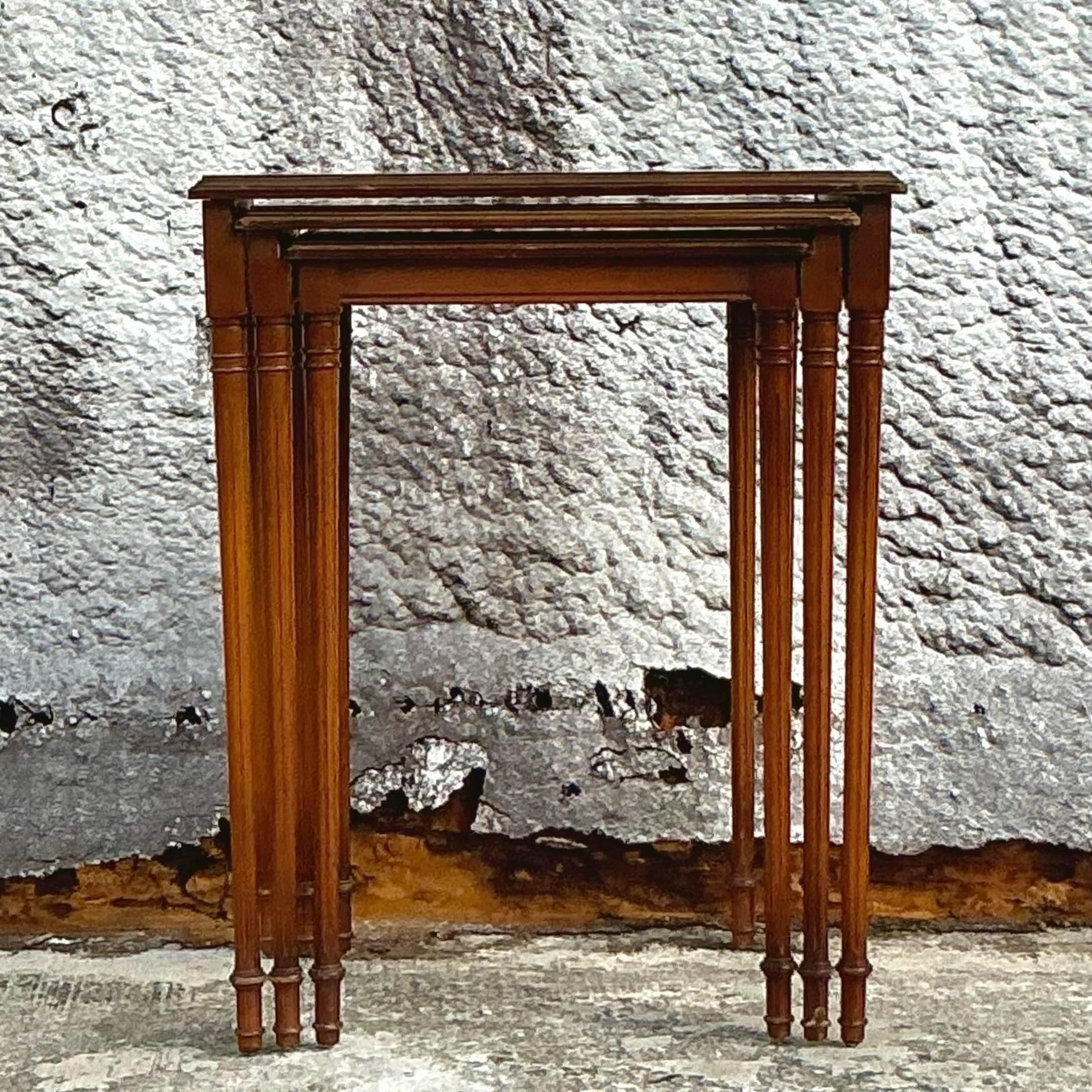 Charming set of three vintage Regency nesting tables, each hand-painted with delicate details and finished in a rich, lacquered sheen. These versatile tables offer a classic look with intricate patterns and gold accents, perfect for adding elegance