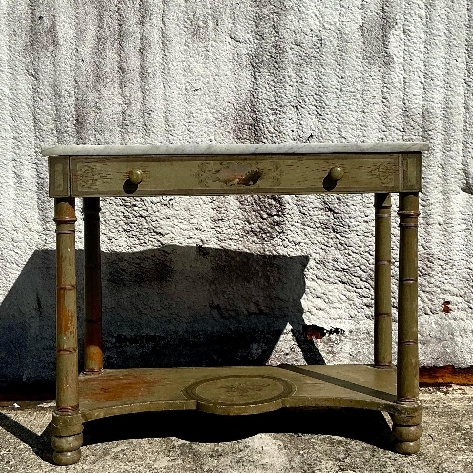 Add a touch of timeless elegance to your space with this Vintage Regency Hand-Painted Stone Top Table. Featuring an intricately hand-painted stone surface, this table boasts exquisite detailing that reflects the opulence of Regency design. The rich,