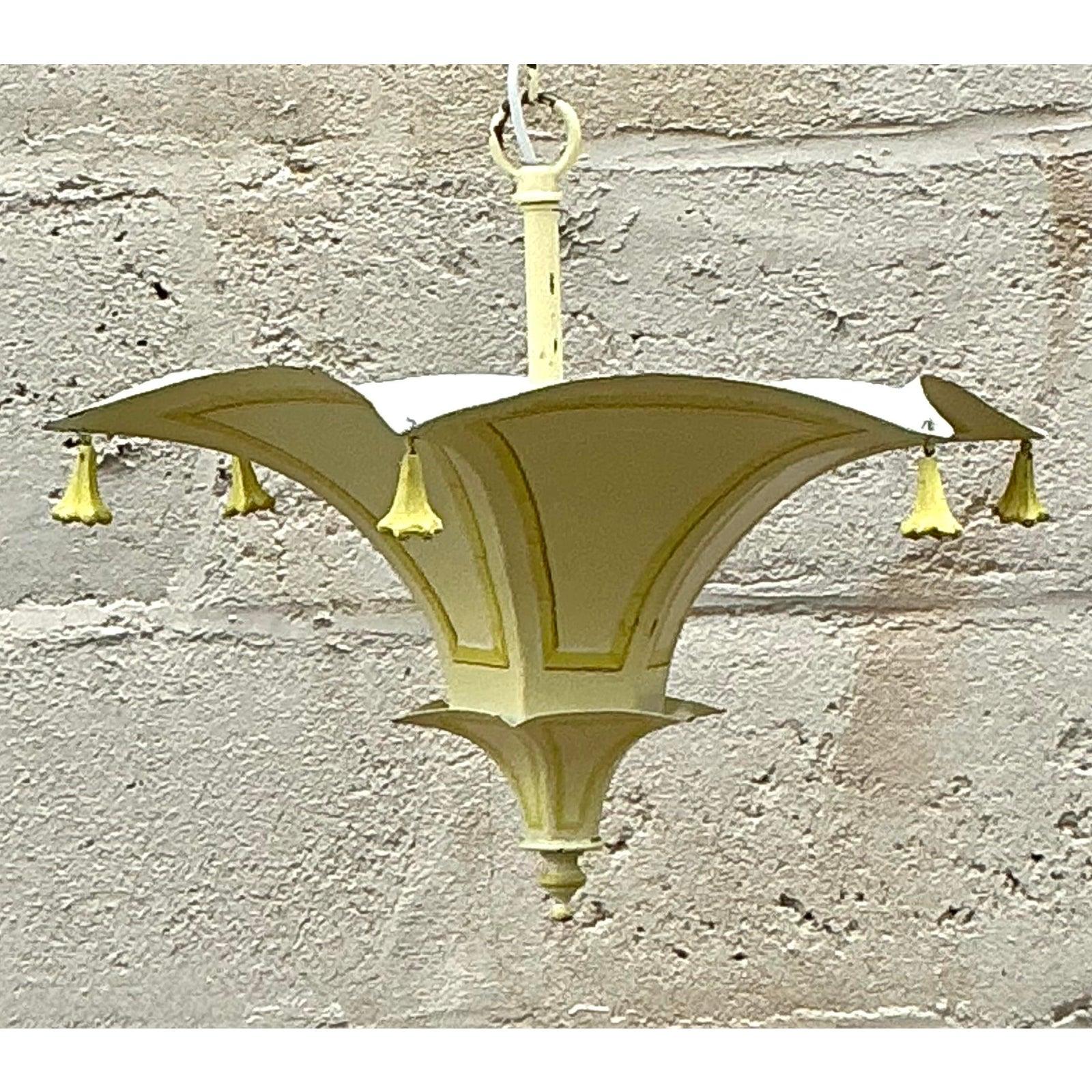 Add a delightful touch of sunshine and worldly sophistication to your interior with this charming vintage tole pagoda pendant. Embodying the playful elegance of the Hollywood Regency era, this light fixture features the iconic upswept Chinoiserie