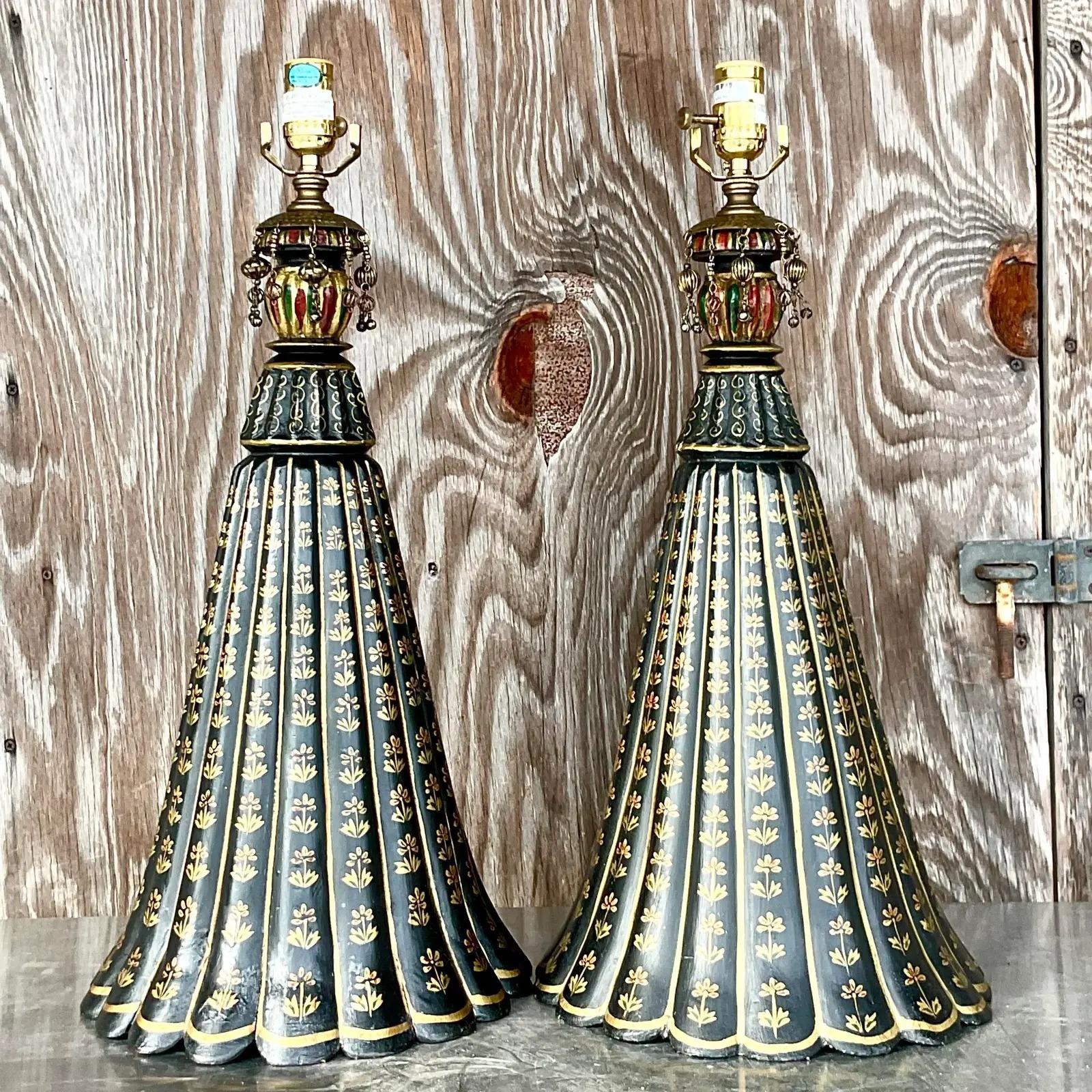 A gorgeous pair of vintage Regency hand painted lamps. A beautiful trumpet shape in black with gorgeous gilt fleur de lys. Dangling charms for extra glamour. Acquired from a Palm Beach estate.

The lamps are in great vintage condition. Minor