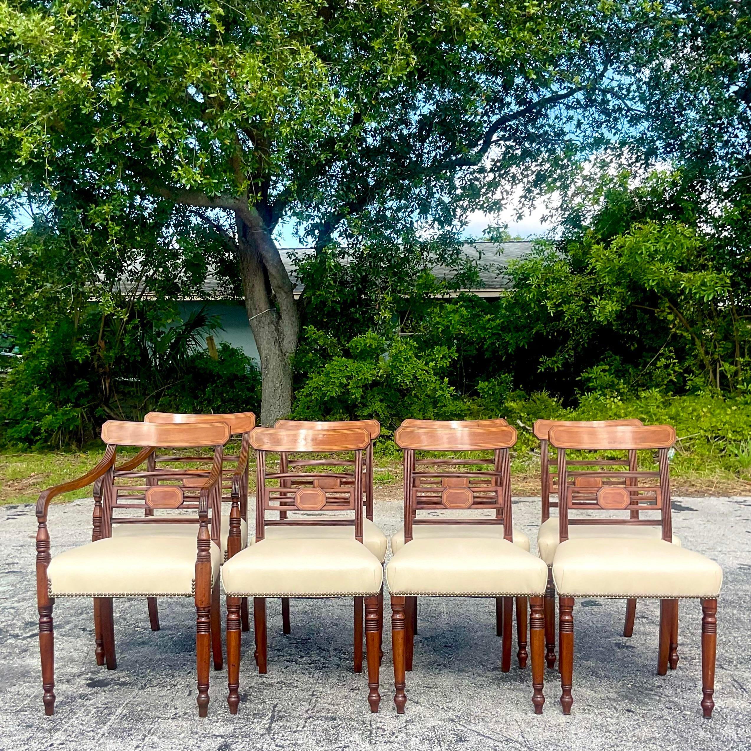 A stunning set of 8 vintage Regency dining chairs. Gorgeous Mahogany frame with chic inlaid tipping along the edge. Upholstered in a neutral leather. Two are chairs and six sides. In pristine condition. Acquired from a Palm Beach estate.

Armchair