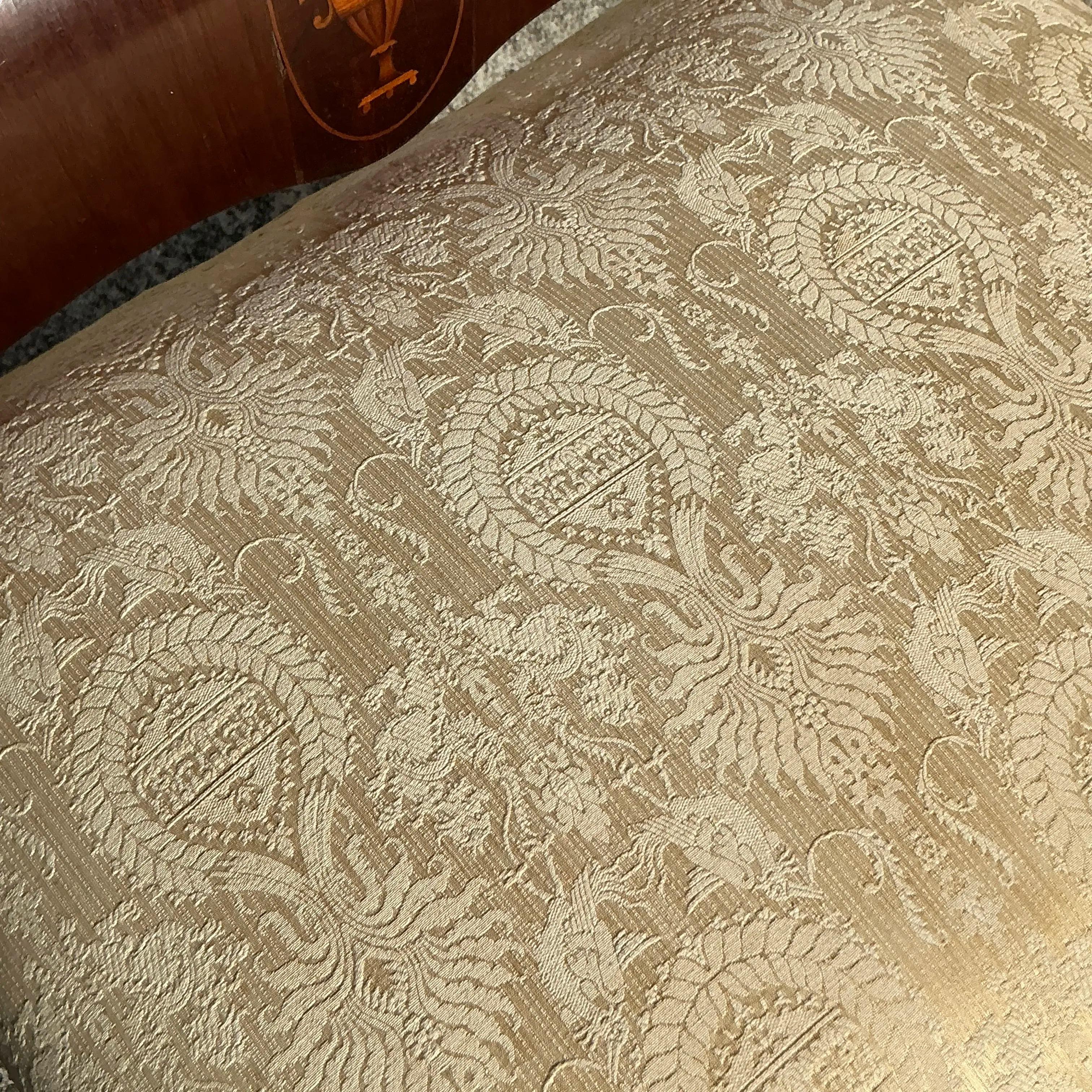 Elegant vintage Regency bench featuring exquisite wood inlay detailing and a refined silhouette. Upholstered for comfort, it blends timeless sophistication with functional style, making it a perfect accent for entryways, bedrooms, or living areas.
