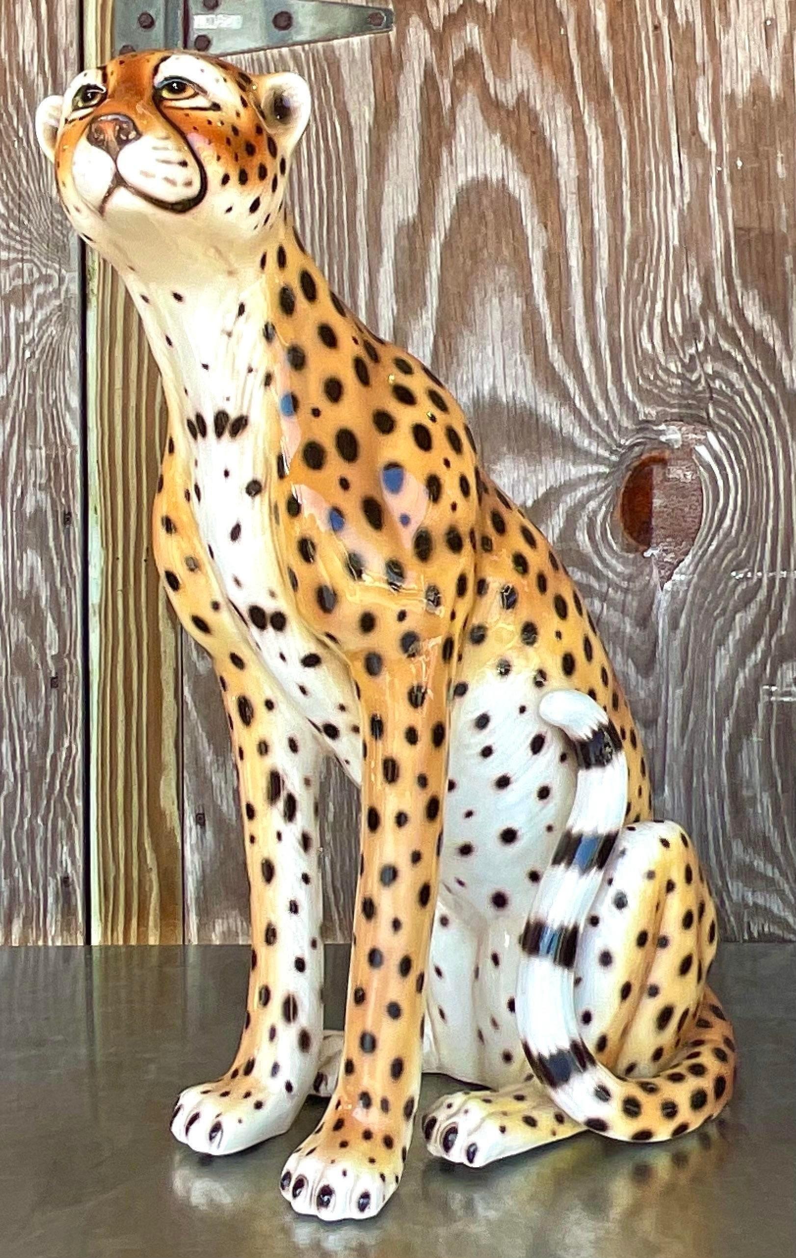 Embrace the exotic elegance of this Vintage Regency Italian Glazed Ceramic Cheetah, a striking piece that embodies the timeless allure of American interiors. With its intricate detailing and bold presence, this cheetah sculpture adds a touch of Old