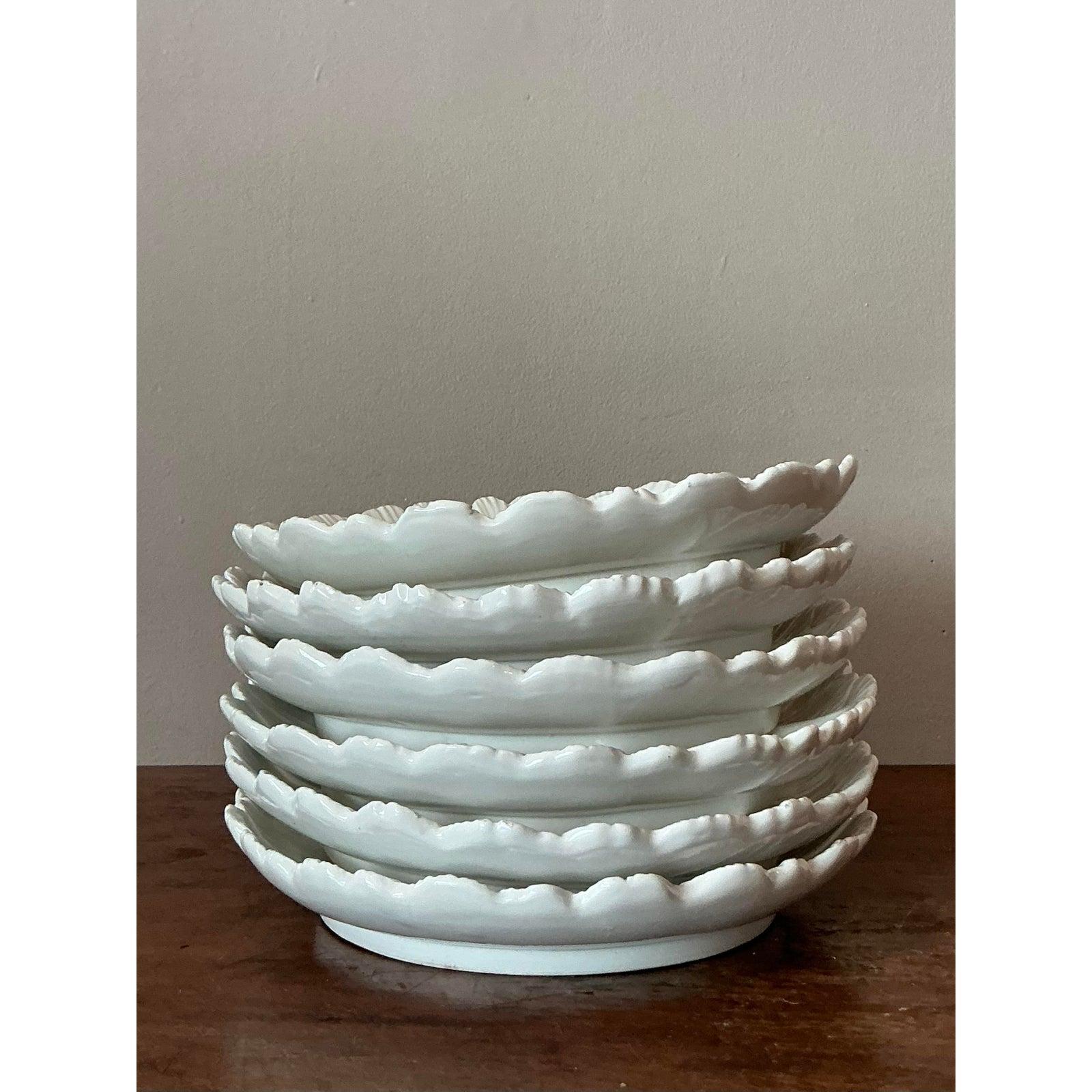 Elevate your entertaining with this charming vintage Italian glazed ceramic luncheon platter, embodying the sophisticated elegance of the Hollywood Regency era. Crafted with exquisite detail, this piece features a delightful scalloped floral design,