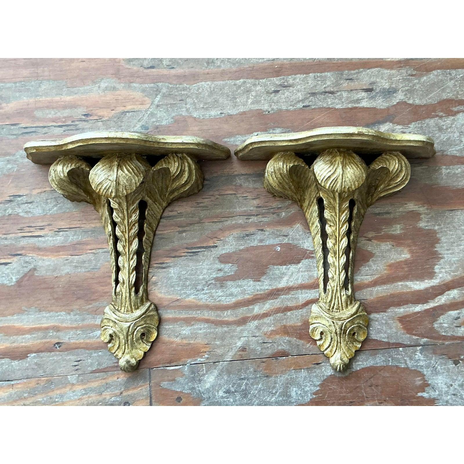 infuse your interiors with the opulent charm of Old World Europe with this striking pair of vintage Italian giltwood wall brackets. Expertly hand-carved in a classic Baroque manner, each corbel features a dimensional acanthus leaf motif that unfurls