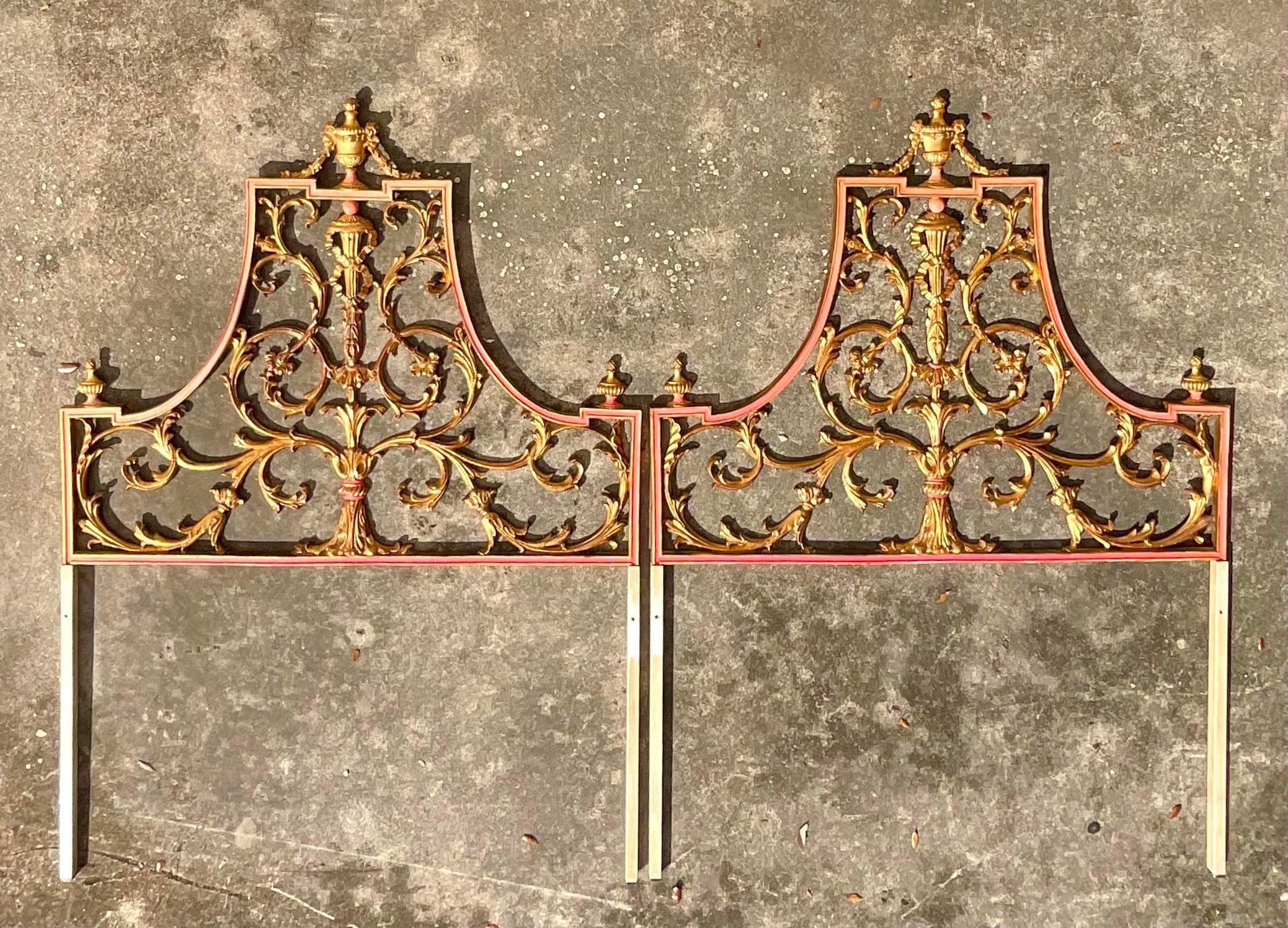 A spectacular pair of vintage Italian twin headboards. Made by the legendary Palladio group. Beautiful gilt over metal in a chic scroll design. Tipped in a deep orange color. Tagged. Acquired from a Palm Beach estate.