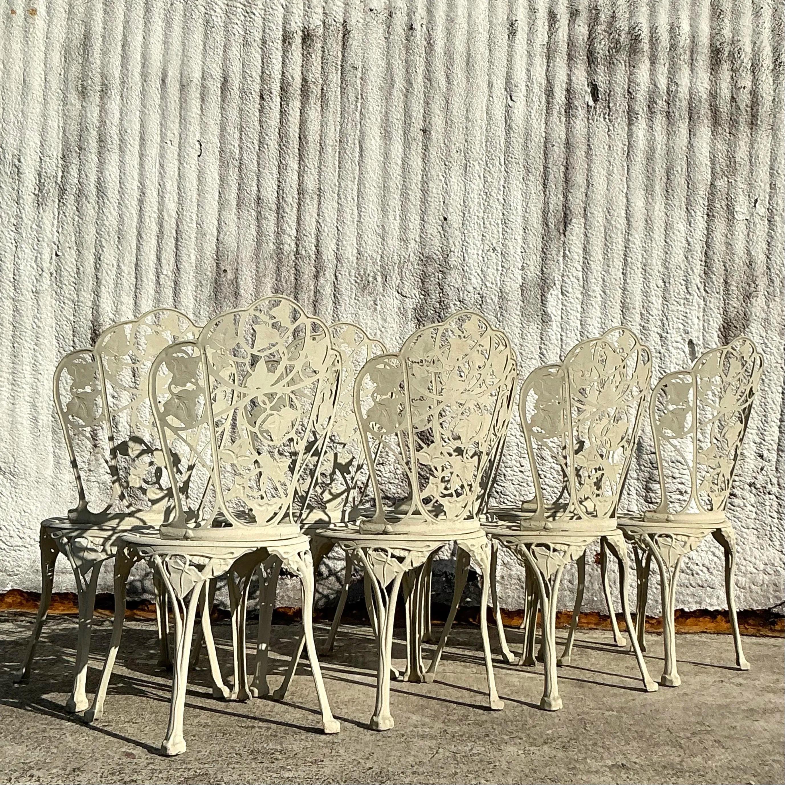A stylish set of eight vintage Regency Ivy cast aluminum outdoor dining chairs, designed for both elegance and durability. Featuring intricate ivy leaf patterns and a robust aluminum frame, these chairs bring timeless beauty to any patio or garden.