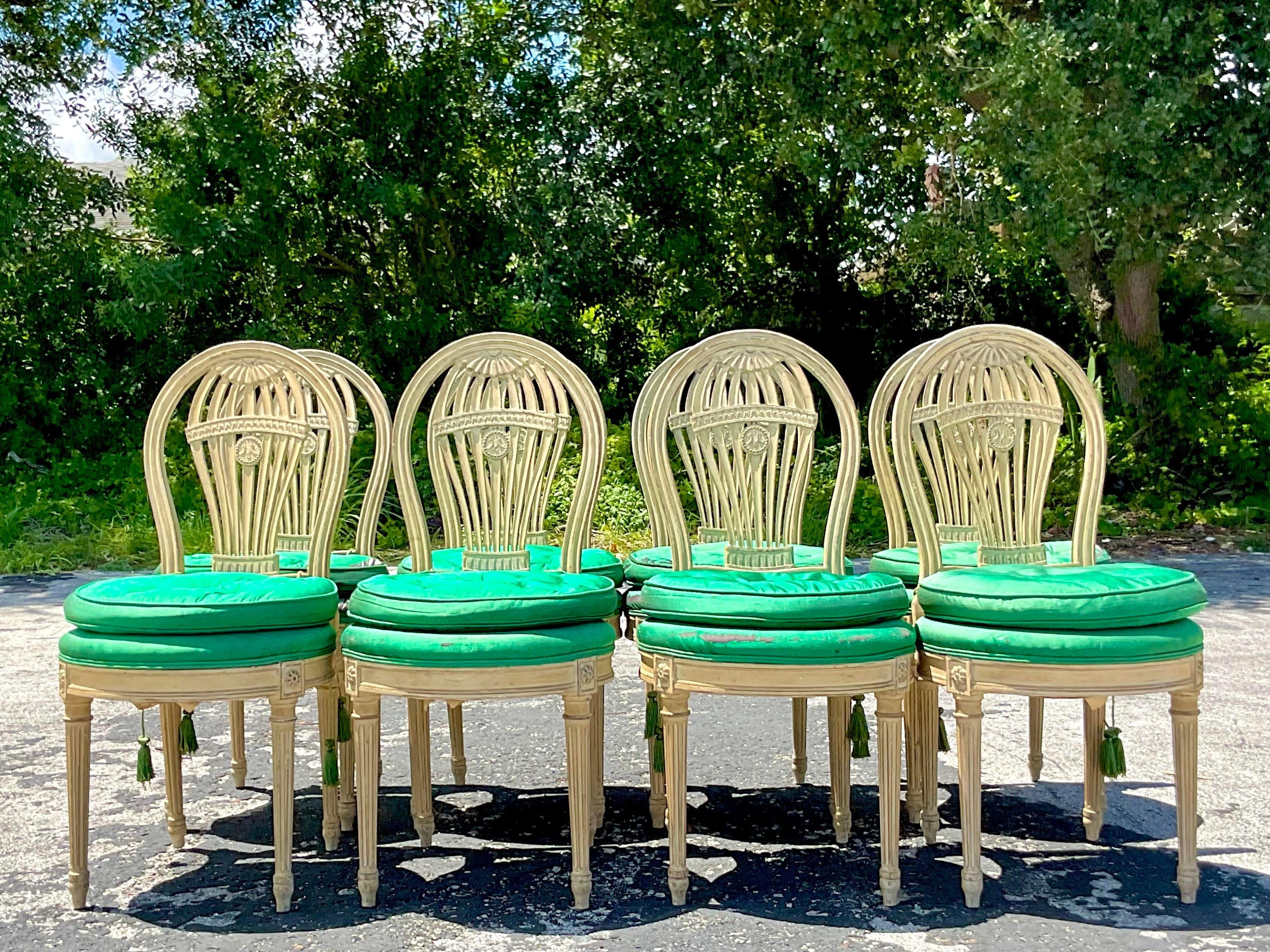 A spectacular set of 8 vintage a Regency dining chairs. Made by the J. Gattuso and Sons group. Done in the manner of Maison Jansen. A beautiful balloon back shape with beautiful hand carved detail. Acquired from a Palm Beach estate.