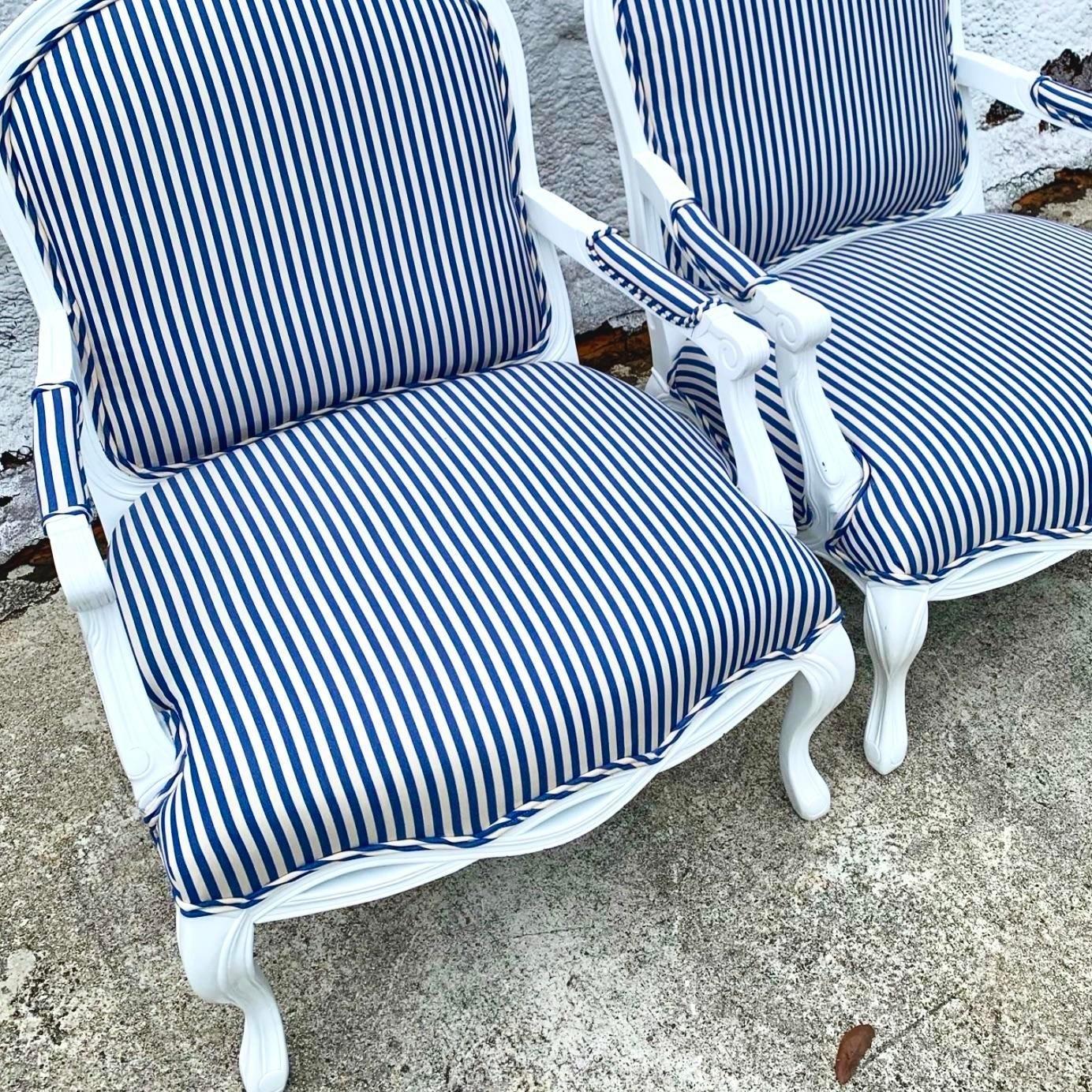 A sensational pair of vintage Regency Bergere chairs. Beautiful white lacquered frame with a new blue and white satin stripe upholstery. Two pairs available on my page. Acquired from a Wellington estate.