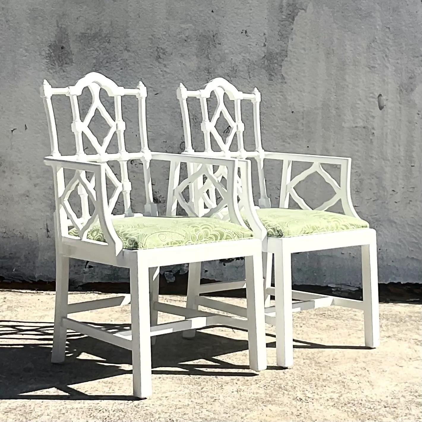 A fabulous pair of vintage regency arm chairs. Beautiful white high gloss layered finish with a bright green upholstered seat. Acquired from a Palm Beach estate.