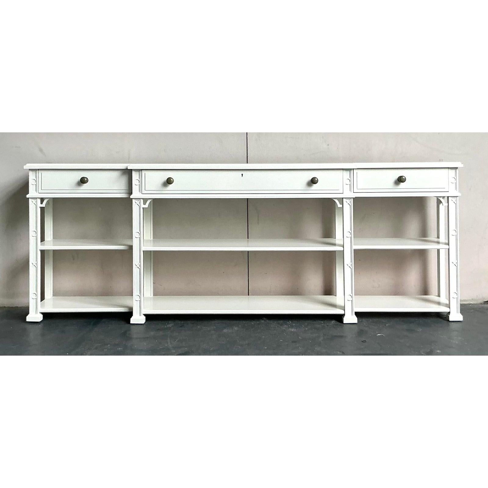 Elevate your interior with this elegant vintage long credenza by Stanley Furniture, showcasing a sophisticated Regency aesthetic. Finished in a crisp white lacquer, this piece features clean lines and subtle classical detailing that lend it timeless