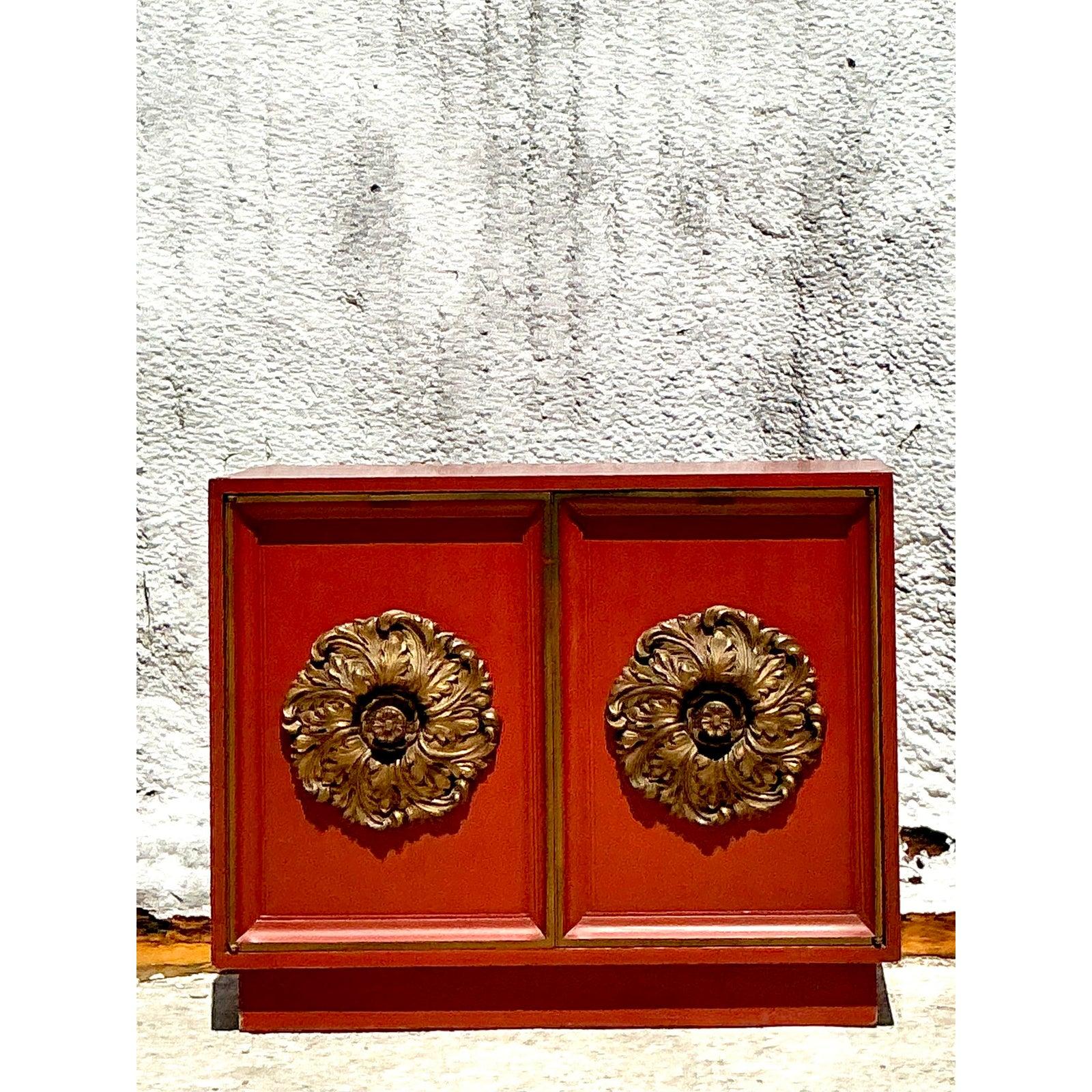 Make a bold statement with this exquisite Vintage Regency Lane Gilt Floral Cabinet, a piece that effortlessly marries classic elegance with Hollywood Regency flair. This striking cabinet features a rich, deep red finish that commands attention,