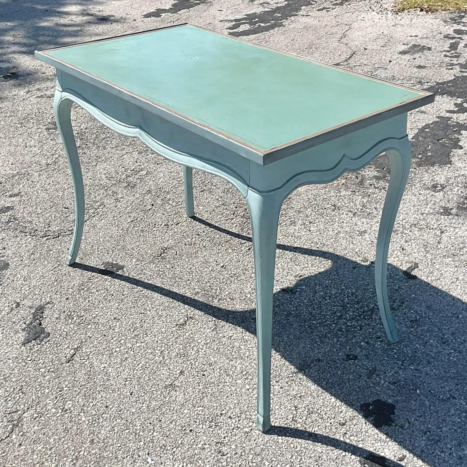 Stunning vintage Regency writing desk. Beautiful cabriolet legs with a chic scalloped trim. Inset leather top with gold leaf detail. The most gorgeous bright blue. Acquired from a Palm Beach estate.

The desk is in great vintage condition. Minor