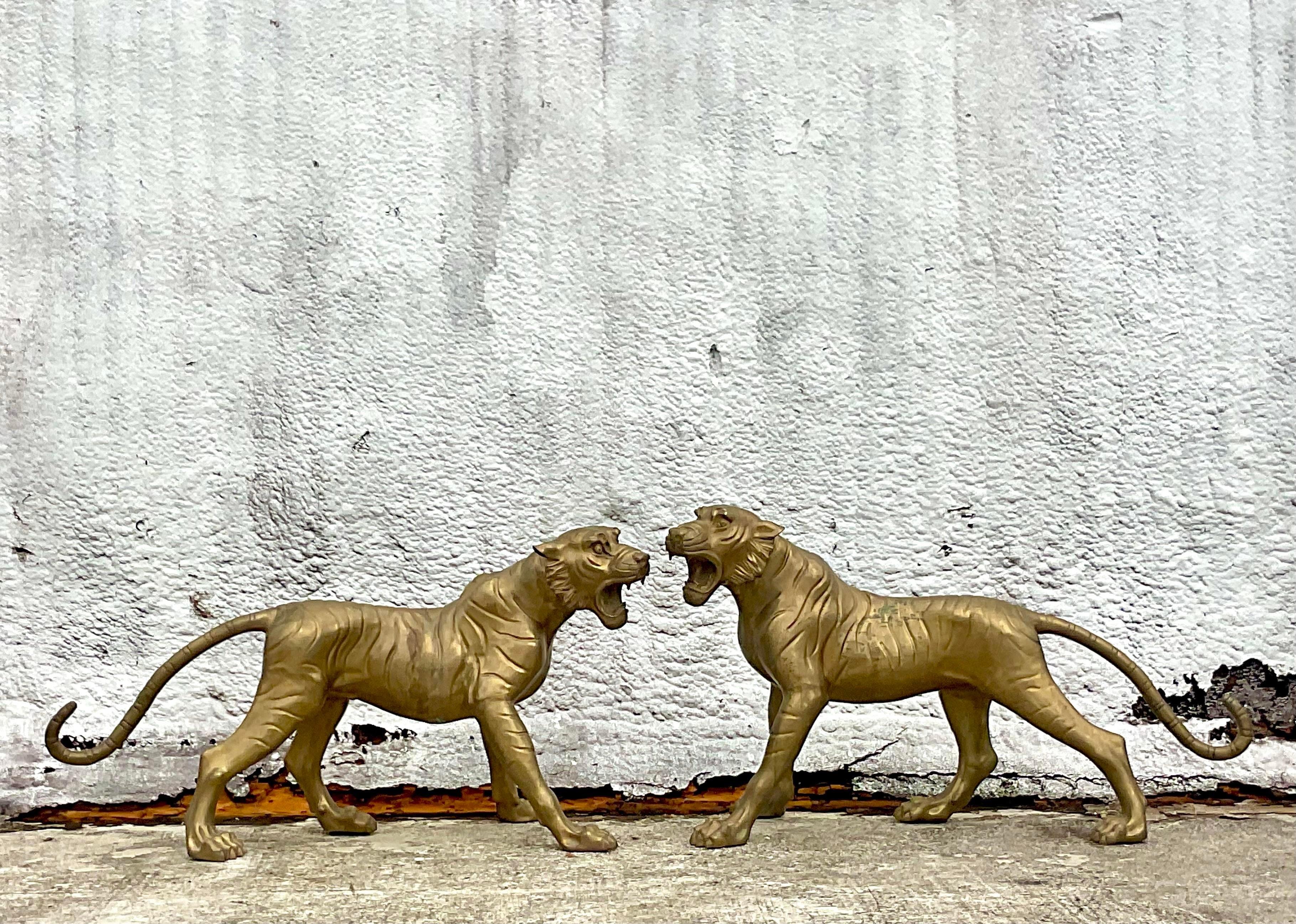 An incredible pair of vintage Regency tigers. Chic life size cats in solid brass. Powerful creatures in a great pose. Acquired from a Palm Beach estate.