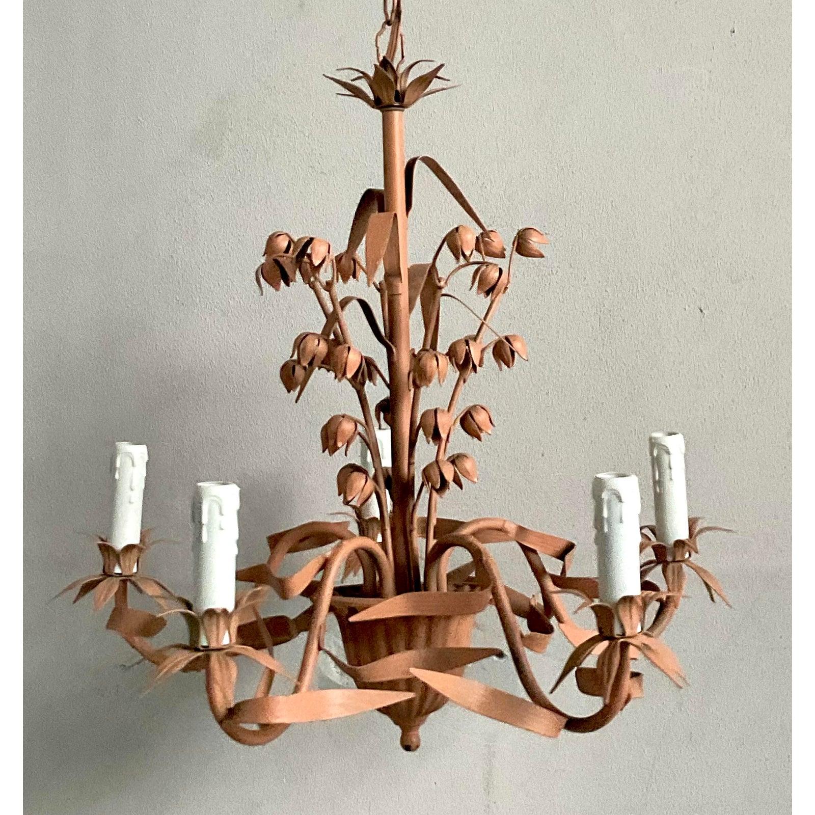 Elevate your space with this exquisite Vintage Hollywood Regency Tole Chandelier, a true testament to the sophisticated elegance of its era. This charming fixture features a delicate sweet pea motif, meticulously crafted from painted tole,