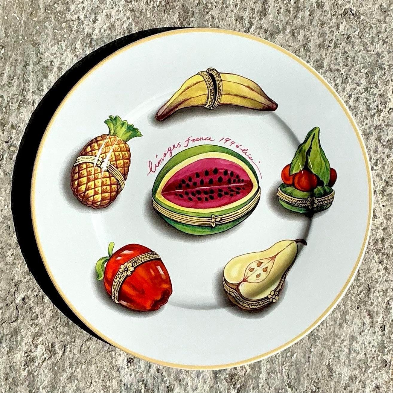 Este asombroso juego de cuatro platos de porcelana Limoges vintage muestra intrincados diseños pintados a mano con temas gastronómicos, desde frutas frescas y vinos finos hasta postres decadentes. Cada plato está adornado con ricos y vibrantes