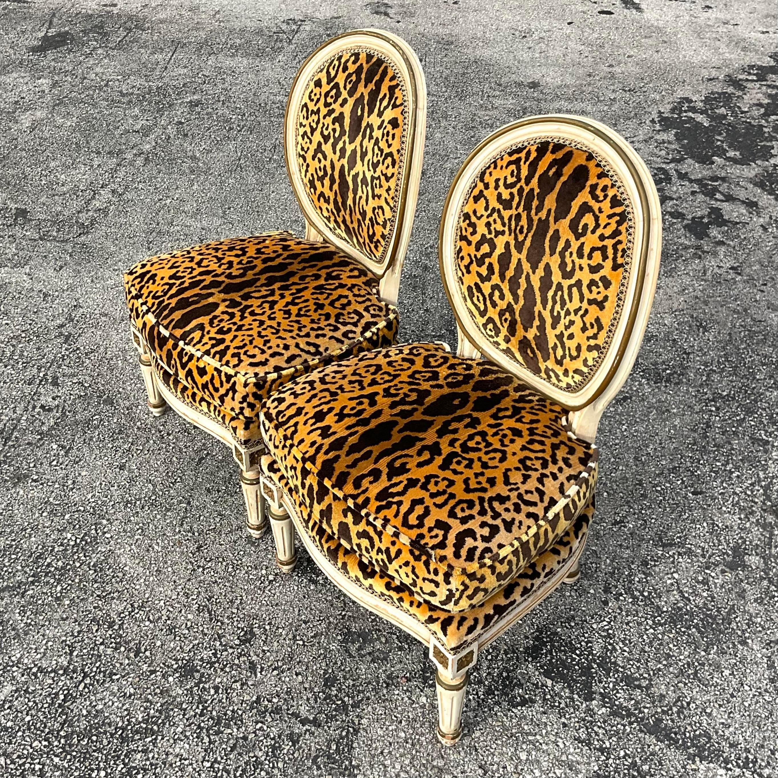 A stunning pair of vintage Regency slipper chairs. A chic Louis XI style with leopard velvet upholstery. Acquired from a Palm Beach estate.