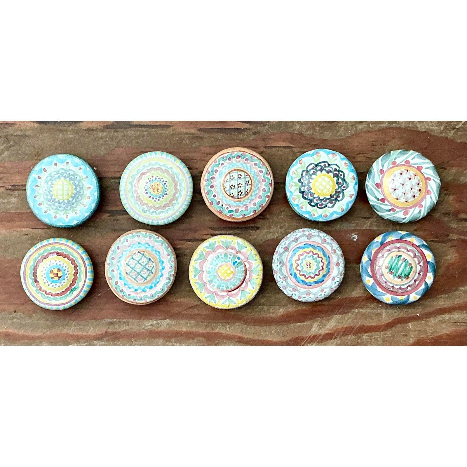 Reimagine your cabinetry or furniture with this charming set of four vintage MacKenzie-Childs ceramic drawer pulls. Dating to the early years of the renowned Aurora, New York studio, these spherical knobs feature a hypnotic, hand-painted 