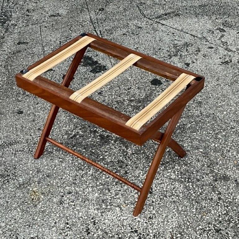 Bring timeless elegance to your living space with this Vintage Regency Mahogany Butler's Tray Coffee Table. Crafted from rich mahogany wood, this piece showcases the classic Regency style with its sophisticated design and functional flair. The