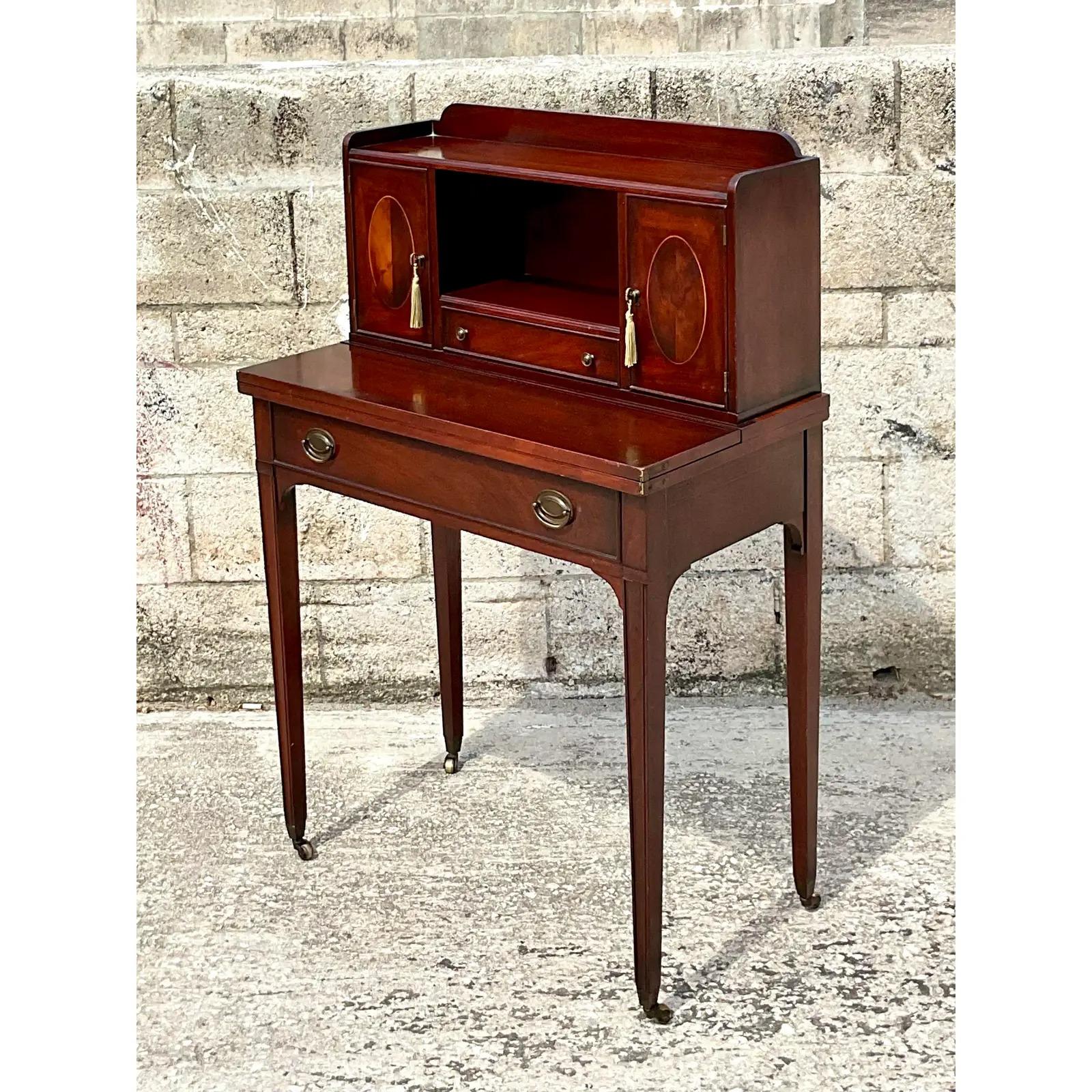 Absolutely charming vintage mahogany desk. A petite secretary with lots of little doors and drawers. Perfect for a home office or guest room. A little chameleon. Acquired from a Palm Beach estate.