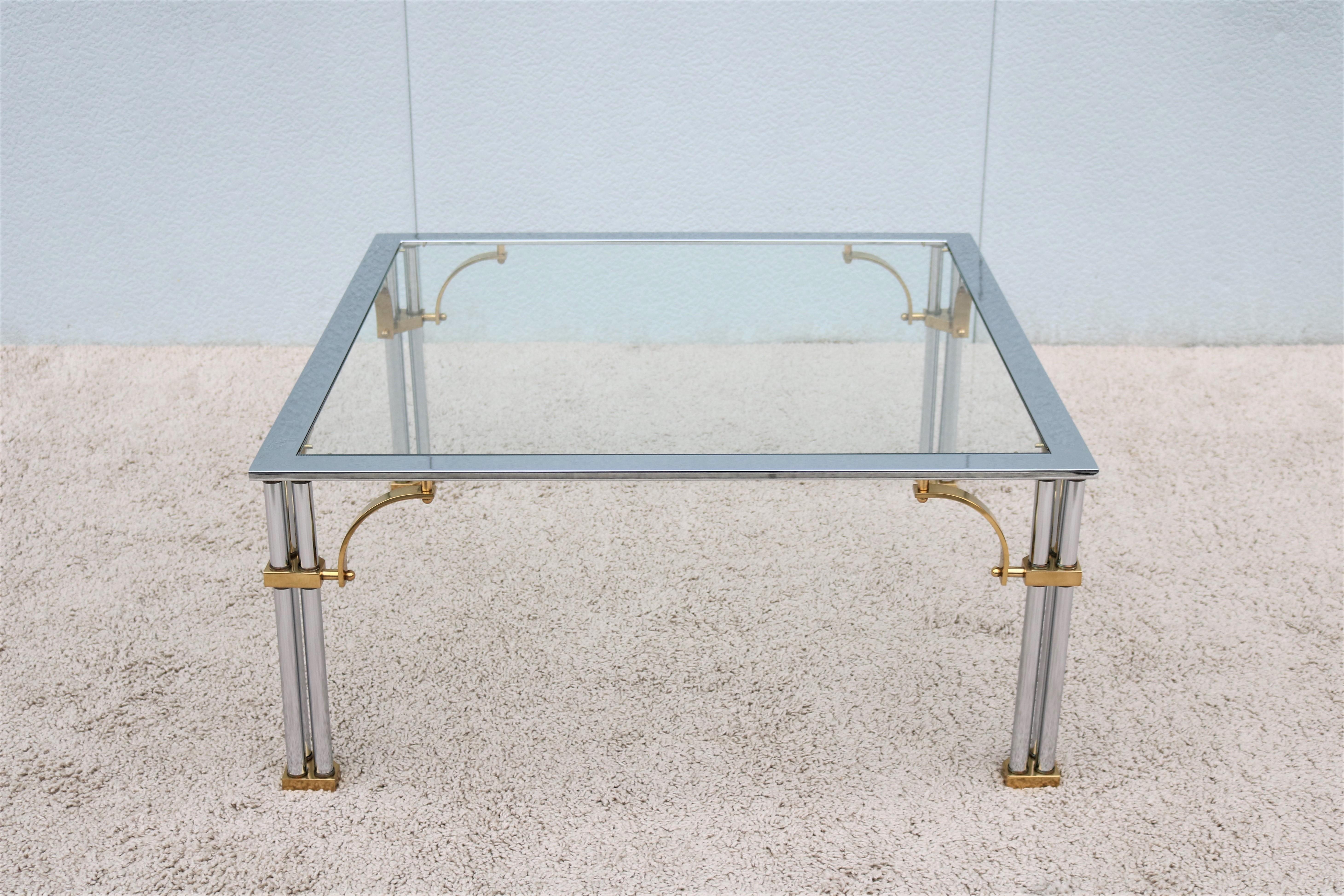 Stunning and elegant looking Hollywood Regency Maison Jansen style Brass Chrome and Glass square coffee table. 
Features tubular chrome legs with brass arched corner supports.
The polished chrome and beautiful brass details make this table