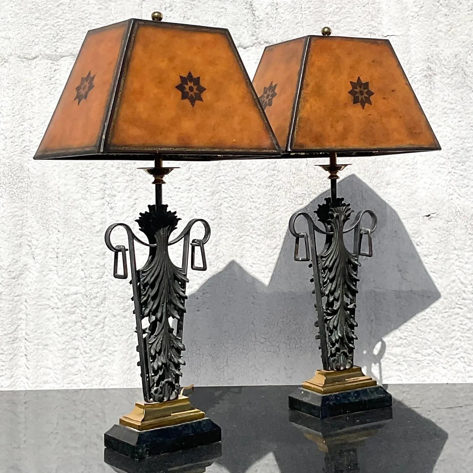 A stunning pair of vintage Regency floor lamps. Made by the iconic Maitland Smith group. Beautiful scroll leaf design with a chic patinated finish. Beautiful matching shades included. Marked on the bottom. Acquired from a Palm Beach estate.

The