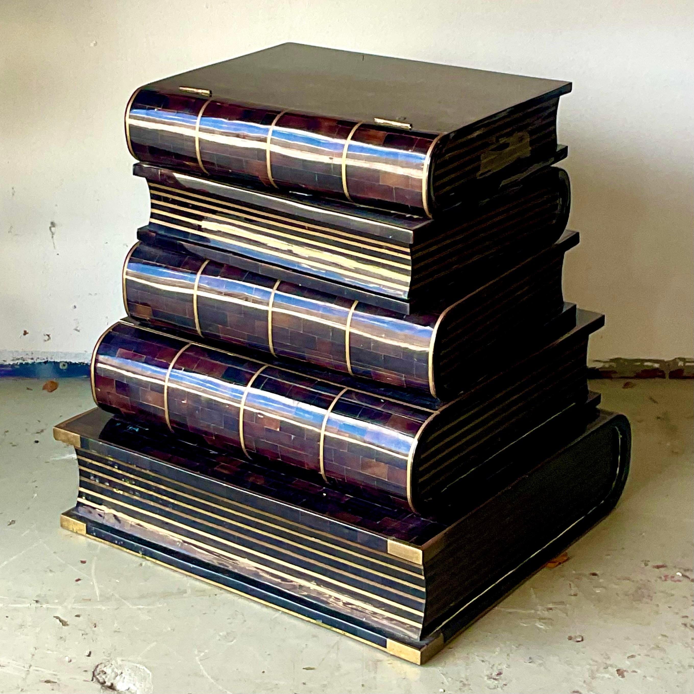 A stunning vintage Regency side table. Made by the iconic Maitland Smith group and tagged in the drawer. A chic little stack of books in tessellated horn and brass inlay. The top flips open for secret storage (never lost the remote again!) and one