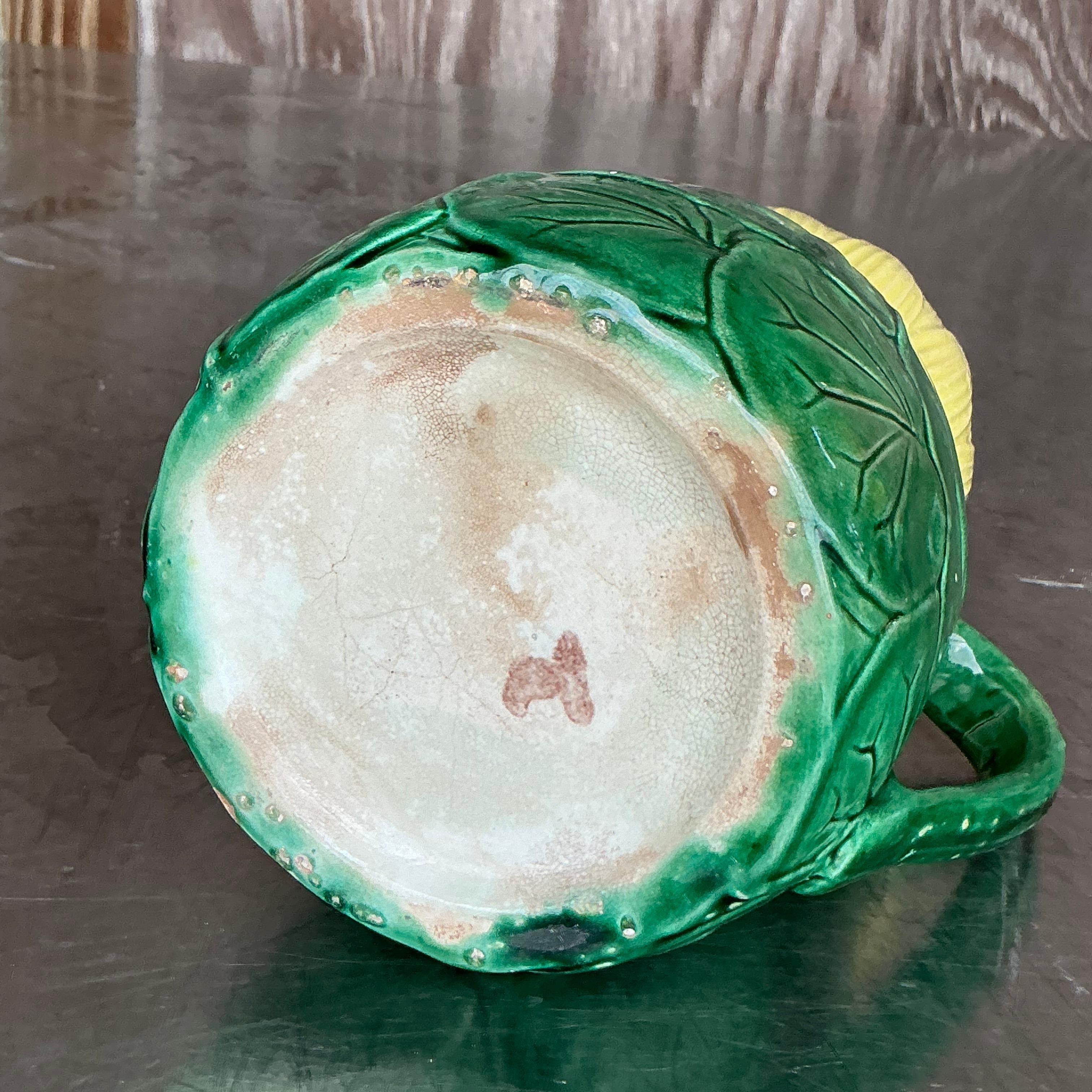 Elevate your décor with the enchanting beauty of this Vintage Regency Majolica Style Lilypad Pitcher. Featuring an intricate design inspired by nature, this pitcher showcases delicately sculpted lilypads and flowers, all finished with a rich, glossy