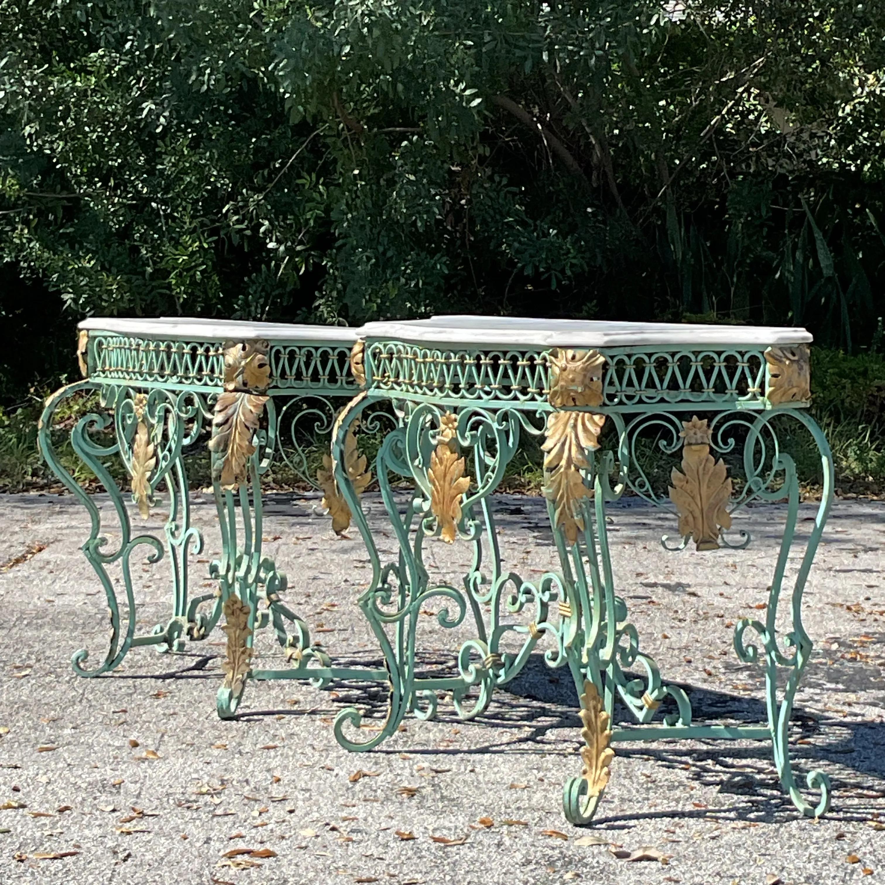 A stunning example of Regency elegance, this vintage console table features a luxurious marble top resting on an intricately detailed wrought iron base. The marble showcases natural veining, adding timeless sophistication, while the wrought iron
