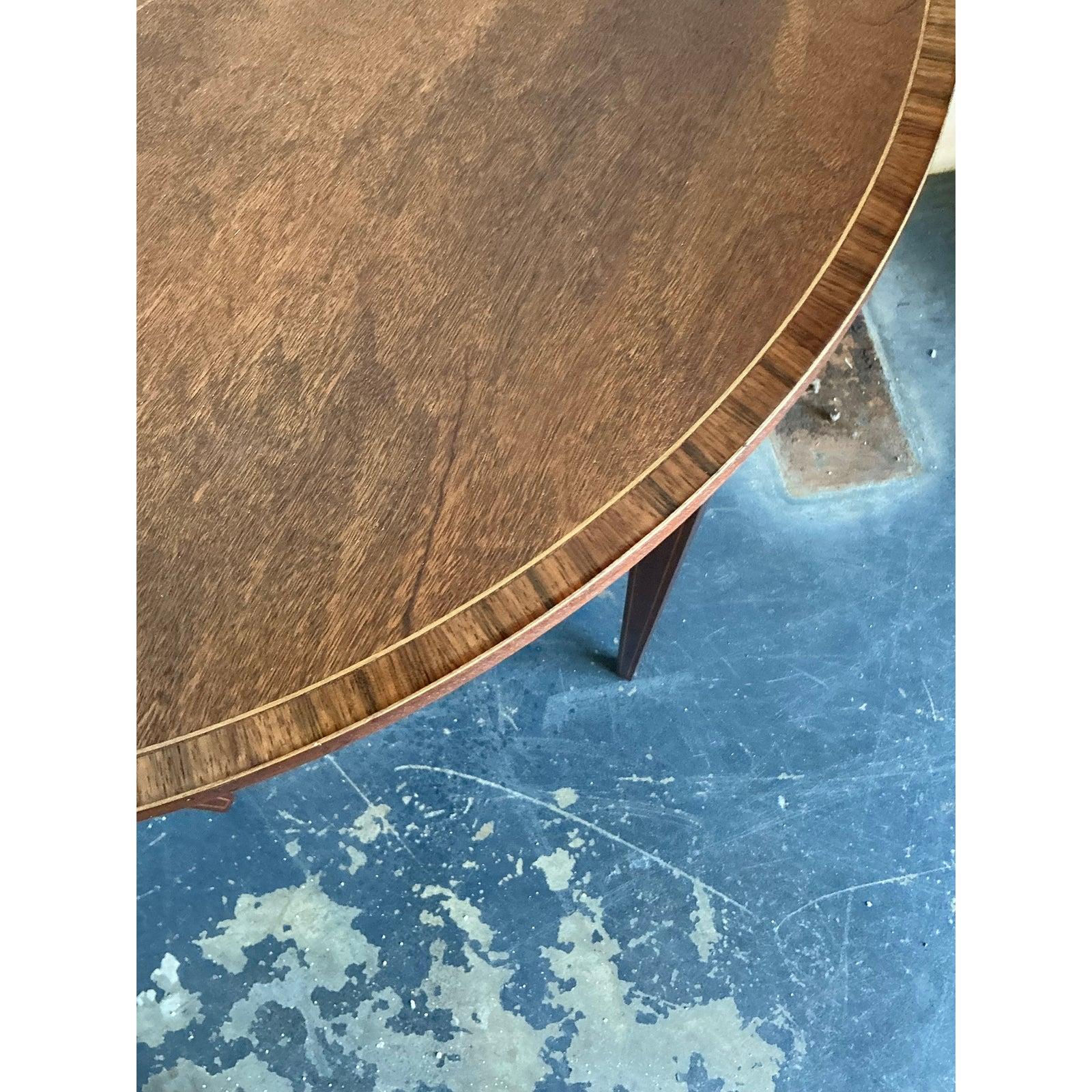 Presenting a superb Vintage Regency Marquetry Demilune Console Table, an elegant piece that effortlessly blends historical charm with refined craftsmanship. This exquisite table is a testament to the sophisticated design principles of the Regency