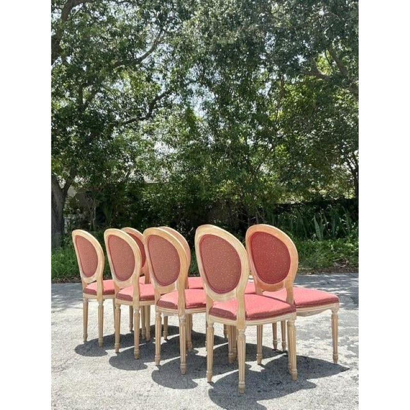 Discover a rare and sophisticated set of eight Vintage Regency Medallion Back Chairs, perfect for infusing your space with neoclassical elegance and enduring charm. Each chair features a beautifully intricate medallion back, a hallmark of the
