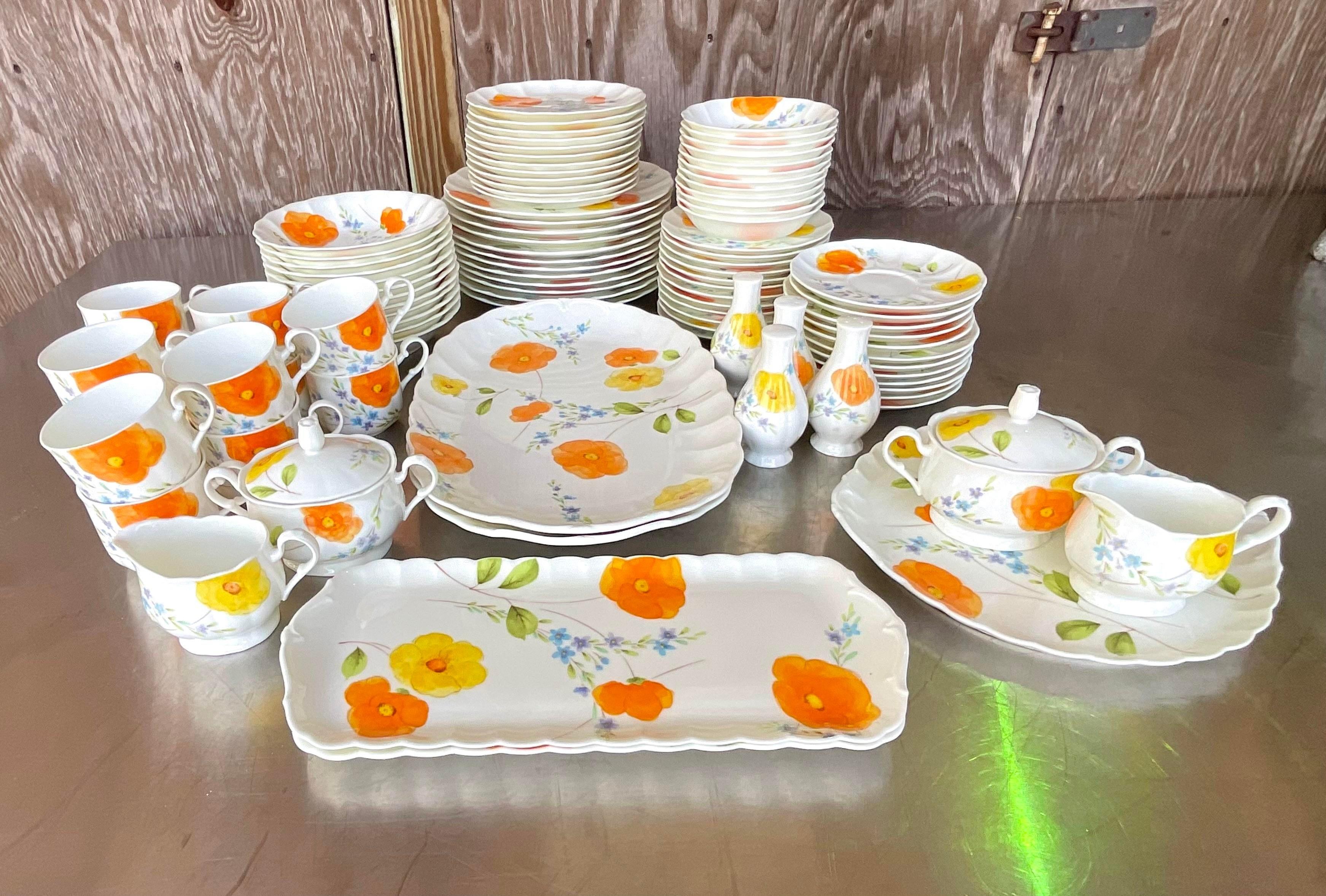 A spectacular set of vintage Mikasa Bone china. A pristine service for 12 in its original wrapping. The coveted “Poppy Love” pattern with its beautiful and colorful floating flowers on an off white background. No chips. Signed on the bottom.