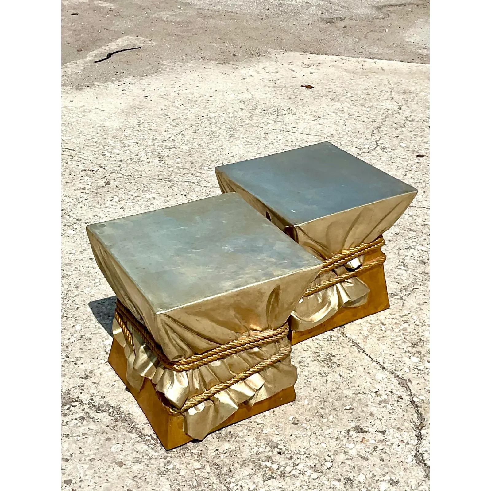 Fantastic pair of molded resin stools. Done in the style of the iconic John Dickinson. Beautiful molded resin in two shades of gold. A fun and dramatic addition to any décor. Acquired from a Miami estate.